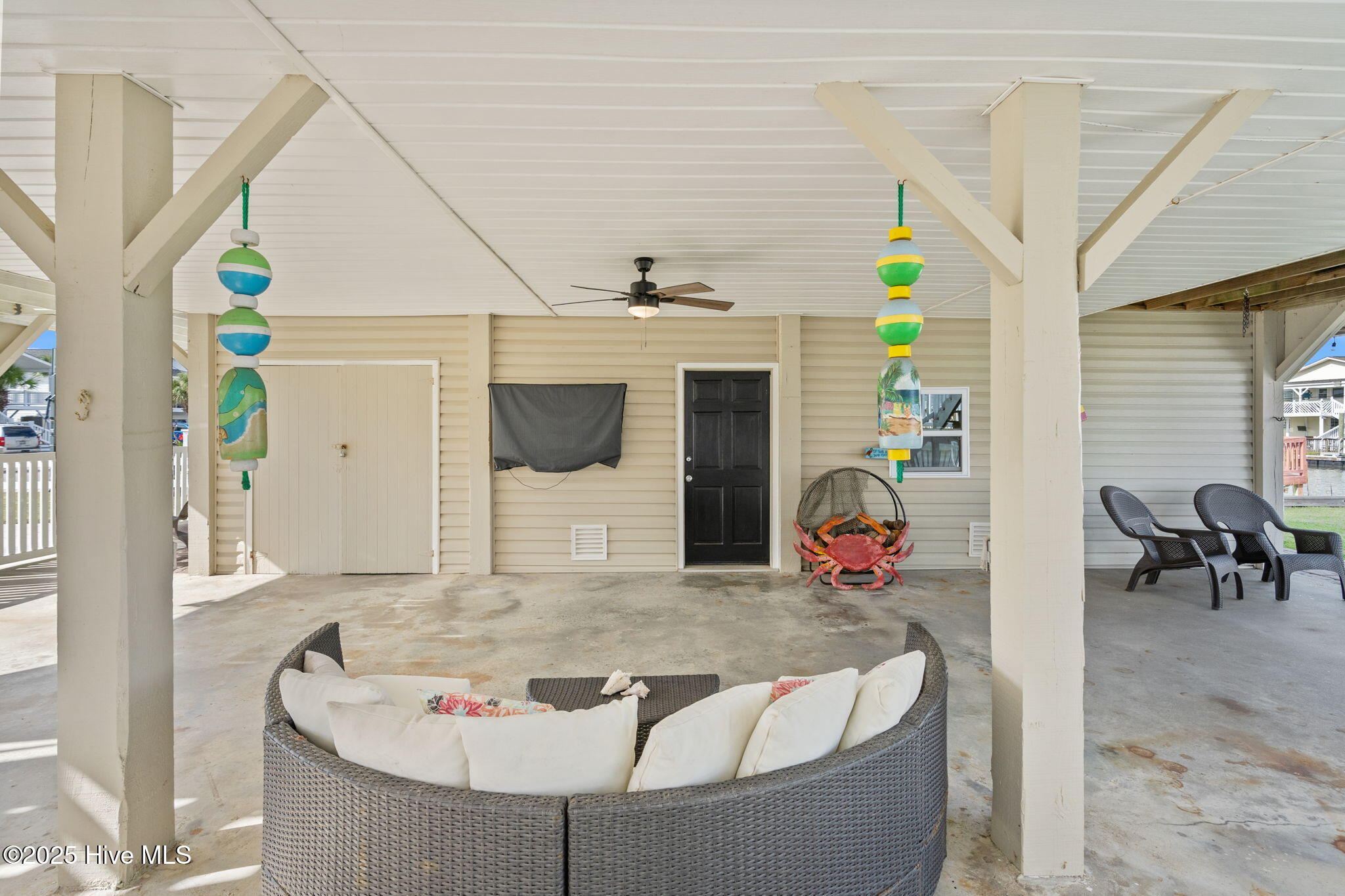 Entertaining area. Enclosed storage with laundry, half bath and golf car parking.