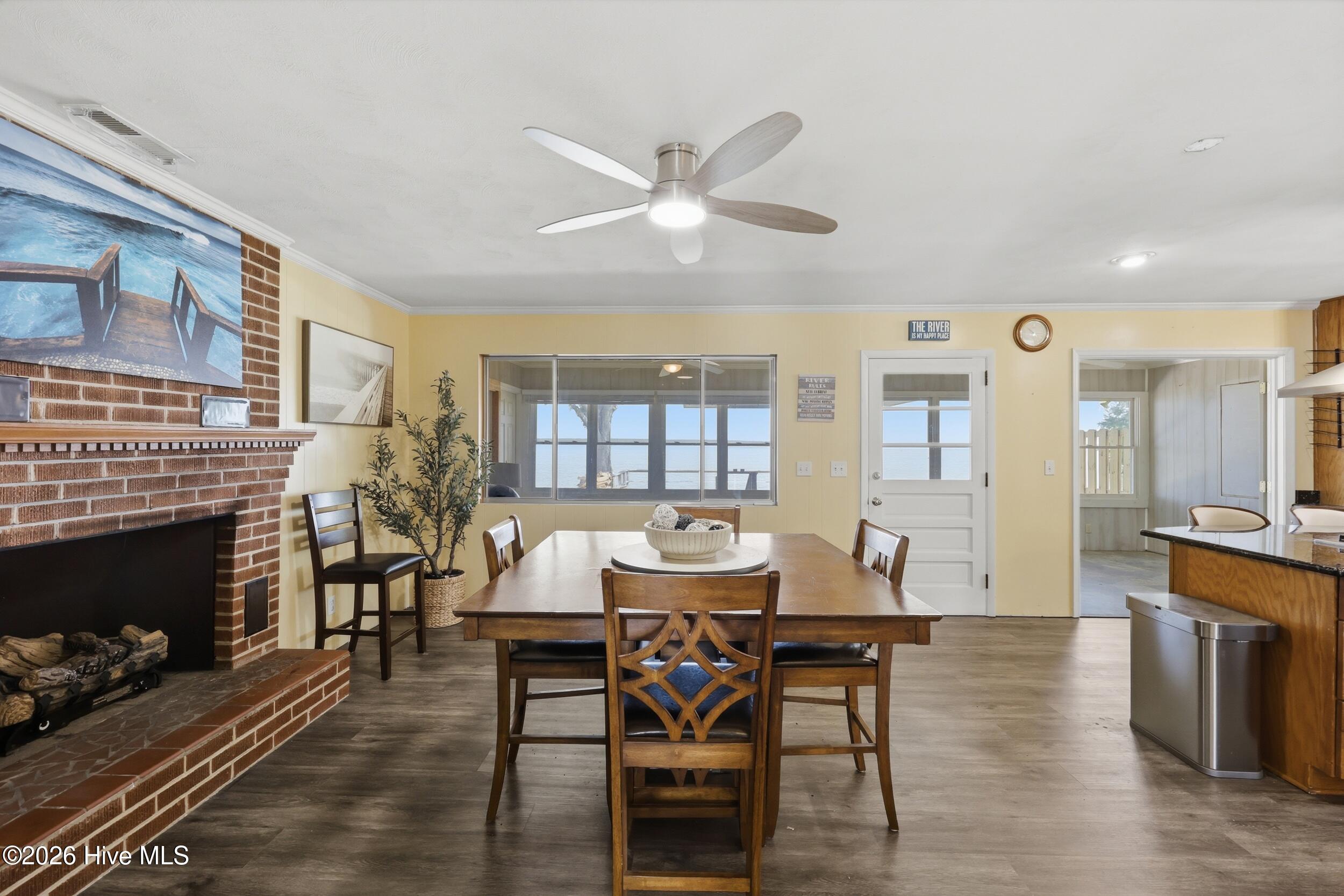 Open to the kitchen is this perfect dining area or den with fireplace and great water views