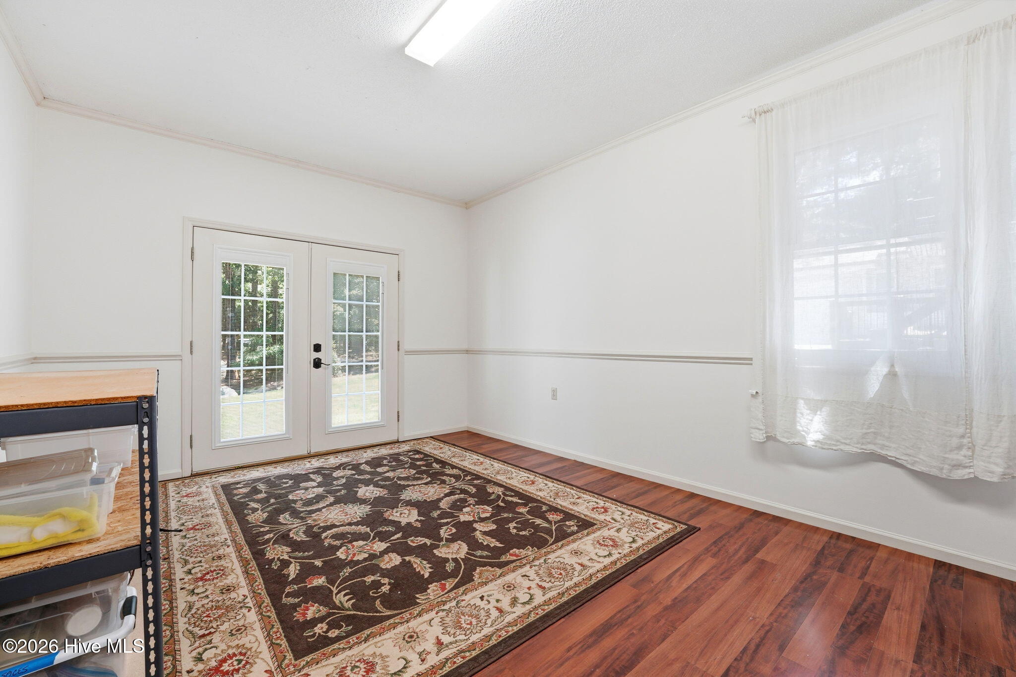 Den or recreation area, Double doors which leads to the grassy front yard. View from the laundry room.