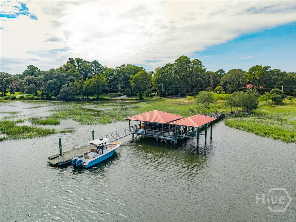 Screened-in dock house with boat lift and floating dock