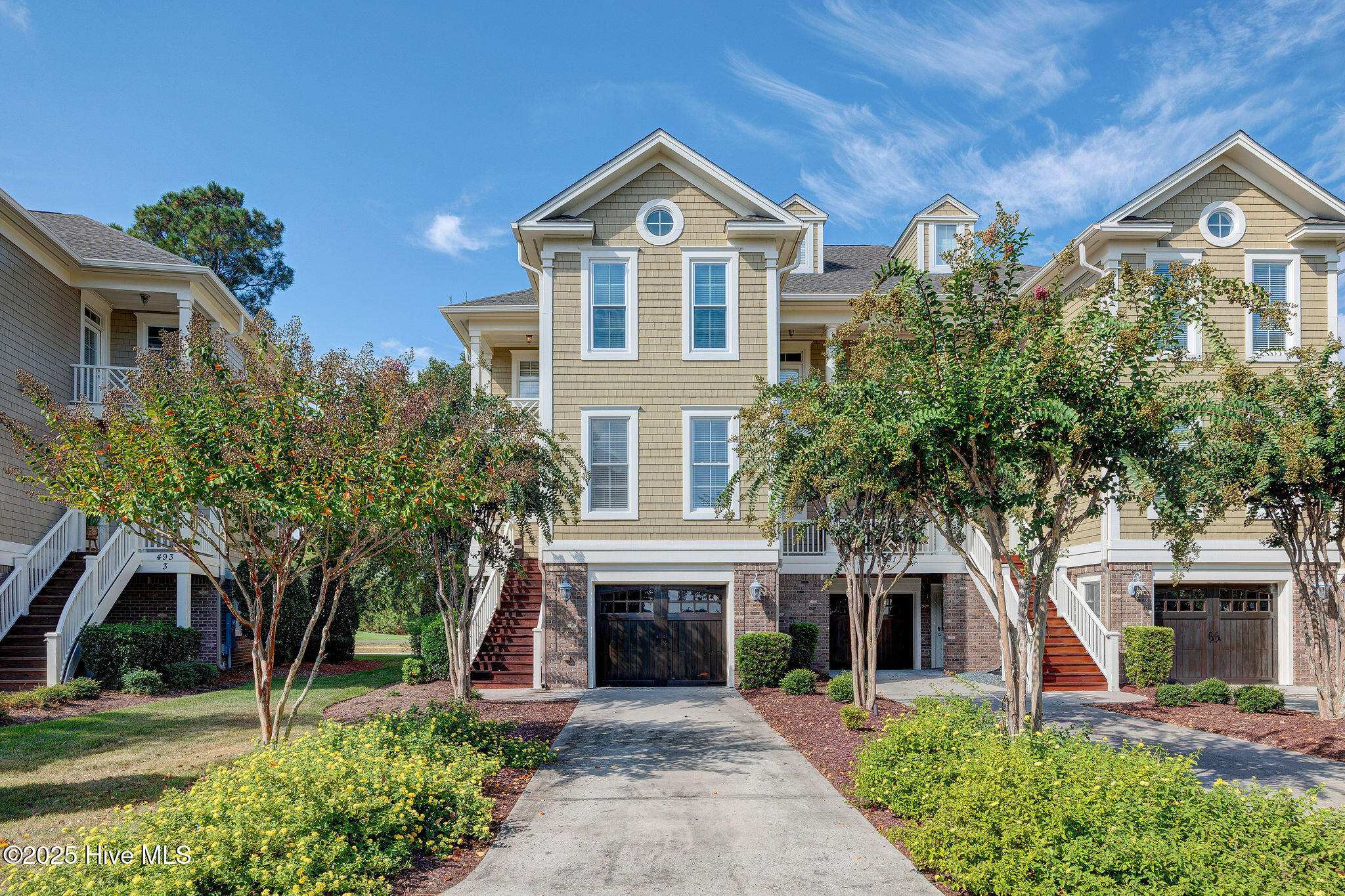 **SELLER ACCEPTING BACKUP OFFERS!!!** Step into a rare Brunswick County find --  a three-level, elevator-equipped townhome in gated Rivers Edge overlooking the Arnold Palmer Championship Golf Course! Thoughtfully updated and impeccably maintained, this home features three bedrooms, each with their own bathroom, plus a flexible ground-floor room with a built-in bar — perfect for a home office, media room, or guest suite. The heart of the home is an airy main level with an open living/dining flow and an updated kitchen with white cabinets, granite counters, and newer (2023) appliances. The primary suite is a private retreat with its own covered porch, elegant bathroom with a jetted tub, and a walk in closet. Every floor opens to outdoor living space (porches, patios, and balconies) so you can relax or entertain while enjoying fairway and marsh views! Move-in ready features include fresh paint, a 2023 roof, 2024 Trane HVAC, 7 new windows in 2025, a 2021 water heater, and a modernized elevator (2025). Rivers Edge is a premier golf community that feels like a year-round resort: enjoy a clubhouse with indoor & outdoor pools, a fitness center, tennis and pickleball courts, regular community events, and exclusive access to an oceanfront beach club on Holden Beach. This is an exceptional opportunity to own a polished, low-maintenance home in an upscale golf-course community — a true showpiece. Don't miss it!