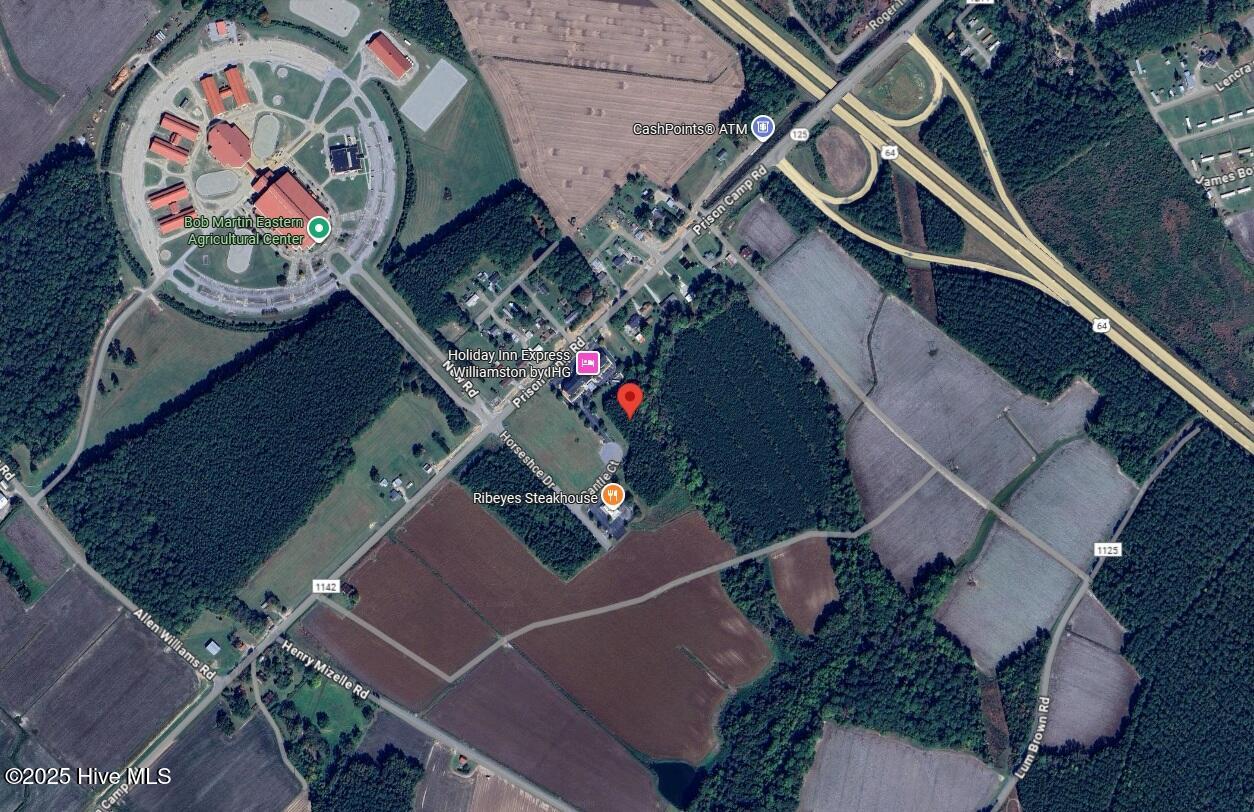 Commercial Highway zoned 2+ acre parcel ideally situated across from the main entrance to Holiday Inn directly across from the heavily utilized Senator Bob Martin Eastern Agricultural Center. This area also sees high traffic volumes from the nearby I-64 access ramps on the recently upgraded main route to the Greenville area. Neighboring Rib Eyes Restaurant adds to the local and transient attraction. Municipal water and sewer services, as well as electric service is already in place at the lot.
