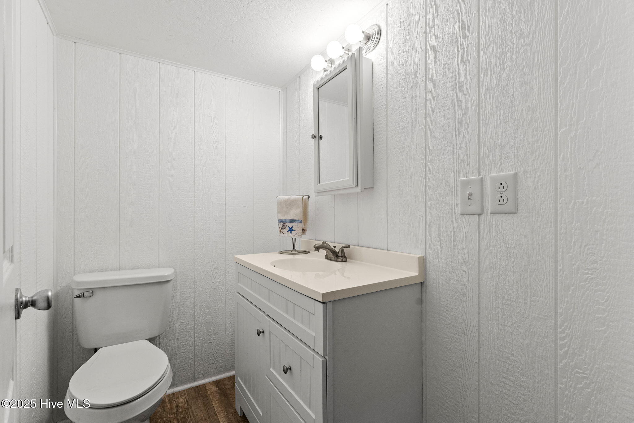 Half-bath on main level near outdoor shower for added convenience .