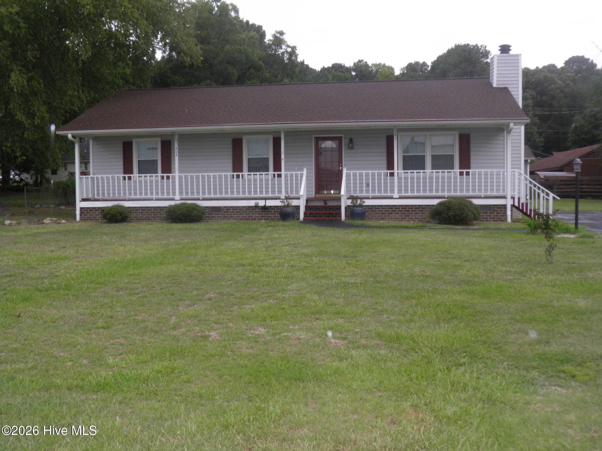 Tucked away in a quiet neighborhood, this charming ranch home is ready for its next owner! Relax on the cozy rocking-chair front porch, or host guests on the spacious back deck. Inside, the updated primary bathroom features a large tile shower and a separate vanity area. Outside, an versatile two-room detached building offers endless potential for a workshop, home gym, man-cave, or studio (power connection previously removed; reinstallation required). Plus, an enclosed lean-to provides excellent extra storage! Sealed crawl space with dehumidifier. Current owner does not have flood insurance but it may be required.  Home did not  flood
