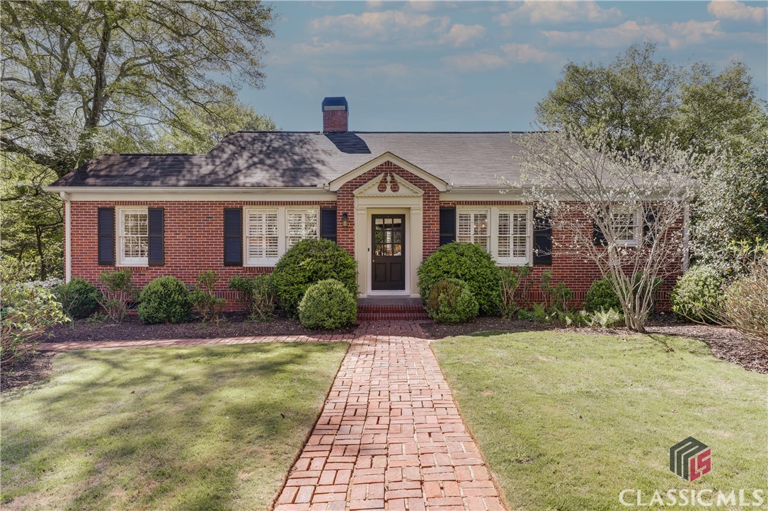 The perfect Five Points cottage has finally hit the market! An iron gate welcomes you to a charming brick pathway where you are surrounded by beautiful hydrangeas and maintenance free landscape. With a luscious and deep lot on a highly desired street, the opportunity to create a larger scale home is unlimited! Walk to retail, dining and Sanford Stadium with ease from this amazing 3 bedroom, 1 1/2 bath cottage. Hardwood floors span the main level which boasts two spacious bedrooms, a renovated full bath, large great room with Fireplace, beautiful home office with a French door and large, eat in kitchen. The renovated kitchen is accented by stained beams, a quilted stainless steel backsplash, gas range and granite countertops. Character abounds with a converted spice rack from an old ironing board, and an industrial style Island with a butcher block top which conveys with the property. The kitchen opens into a keeping room with space for both a sitting area and a large table and chairs.  Upstairs is home to a large third bedroom or flex space with gorgeous heart pine floors and a half bath. Plans have already been drawn for a large renovation to give you an idea of the potential for growth with this property! These plans are available upon request.Entertaining will be easy with the level, well groomed, private yard!** Under Contract before Published**