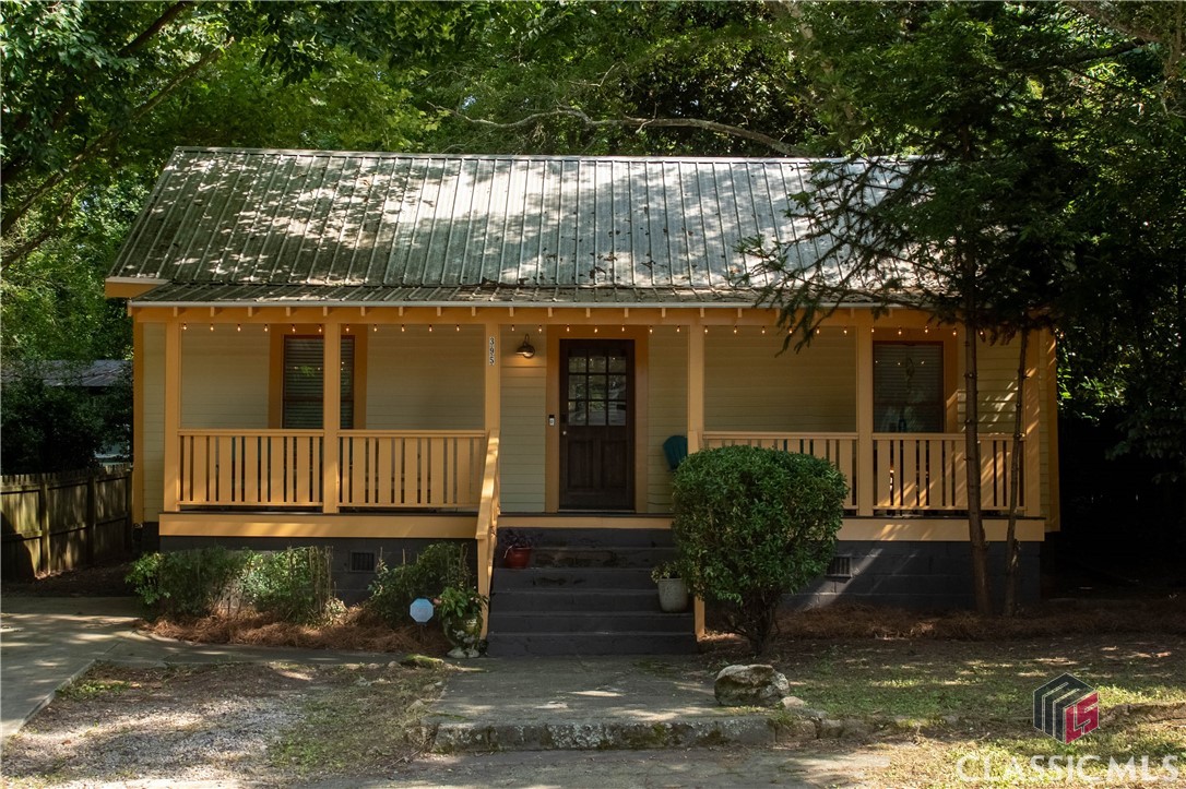 Welcome to 395 Cleveland Avenue, a rare in-town cottage offering the perfect blend of historic character, smart updates, and everyday livability. Located in the Johnny Lay Burks (Chase Street) Elementary School zone and just blocks from Boulevard, Normaltown, and Downtown, this three-bedroom, two-bath home sits at the heart of what makes Athens special.

Restored in 2015 by preservationist David Bryan, the home retains its classic 1920s feel with original hardwood floors, high ceilings, and curated finishes throughout. The open layout moves easily from the living room to the dining area and kitchen, where you’ll find butcher block counters with a reclaimed wood front, open heart pine shelving, sleek cabinetry, and a full pantry. Custom built-in bookcases now anchor the living room, adding both beauty and function.

The crown jewel of the home is the newly constructed screened-in porch. Thoughtfully designed with floor-to-ceiling screening, fans, lighting, and peaceful woodland views, this space extends the living area outdoors and makes the most of the deep, private backyard. The lot features a rare mix of mature native trees, including magnolia, oak, pecan, and a striking monkey puzzle. A detached outbuilding on slab foundation provides space for a future studio or workshop.

Other features include a metal roof, upgraded insulation, off-street parking, and one of the most walkable locations in town. Buvez, Normaltown Brewery, Hidden Gem, Sunroof Coffee, and Nighthawks are within a stone's throw. With so few properties offering this mix of location, quality, and outdoor space, 395 Cleveland Avenue is truly one of a kind.