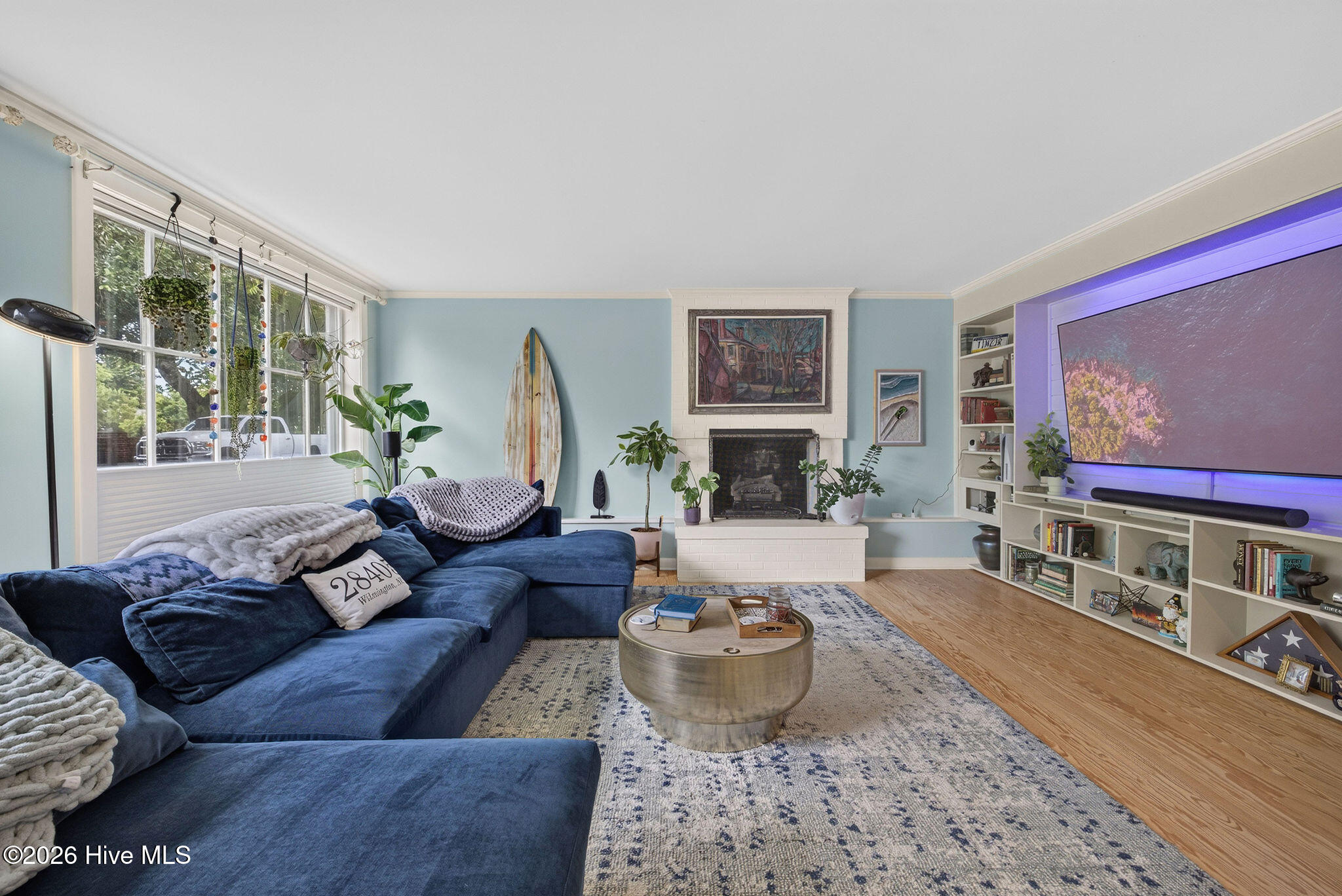 Huge split level living room with beautiful Pine flooring, gas fireplace and entertainment center.