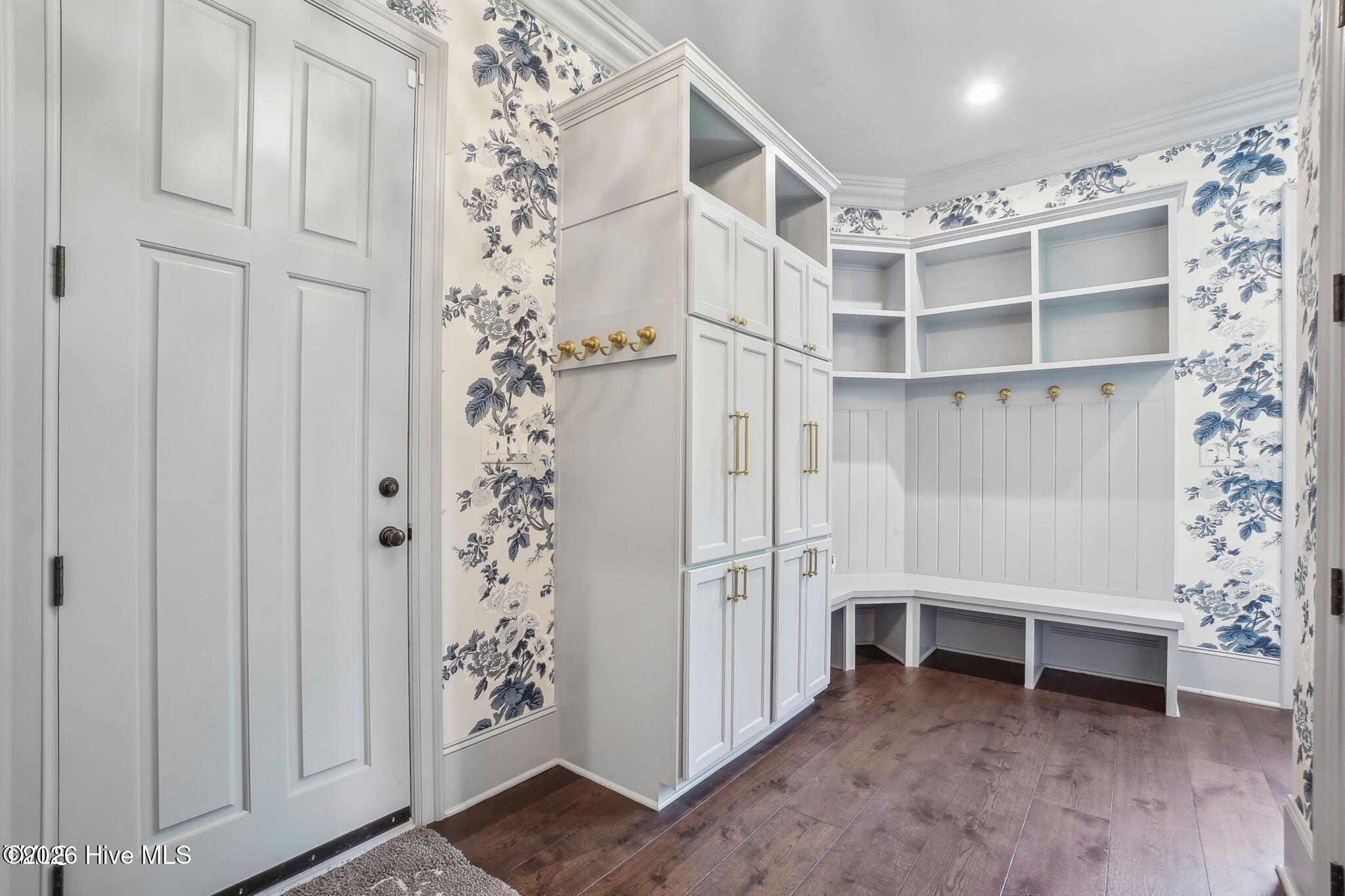 Huge mudroom with built-in cabinetry and dog area with lockable dog door.