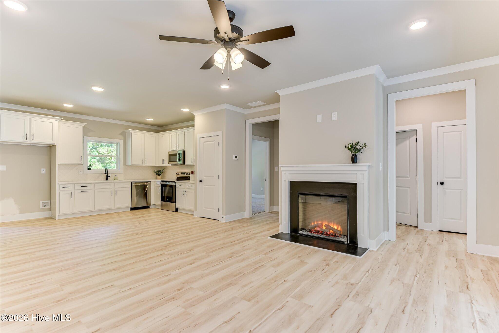 Open, split floor plan, kitchen/living/dining, hallway to Guest Bedrooms
