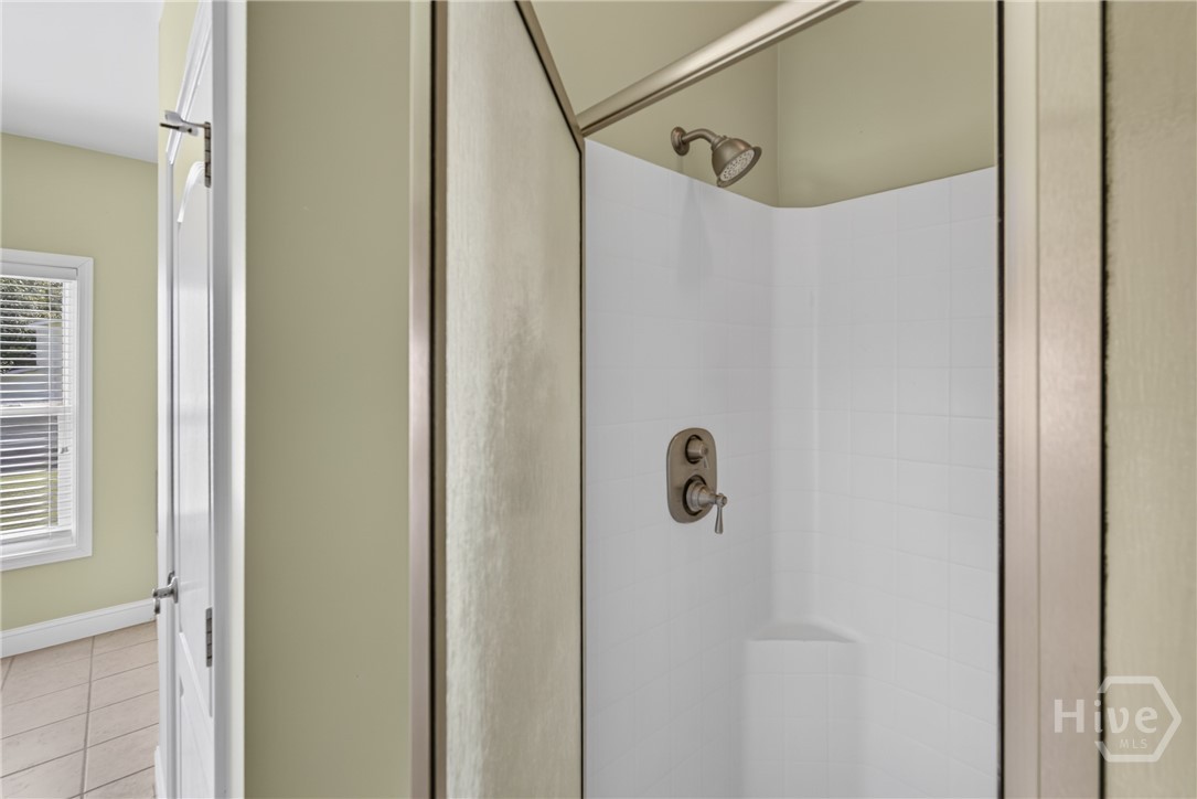 Master bath shower stall and private water closet.