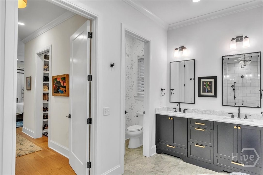 Primary suite bath features double vanity, water closet, separate tub and shower.