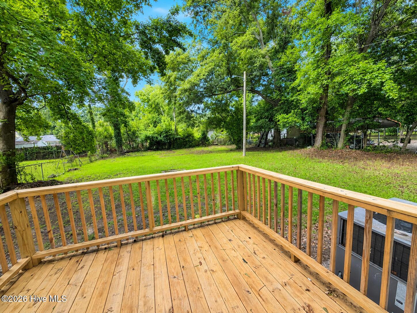 23_sunny_backyard_deck_with_greenery