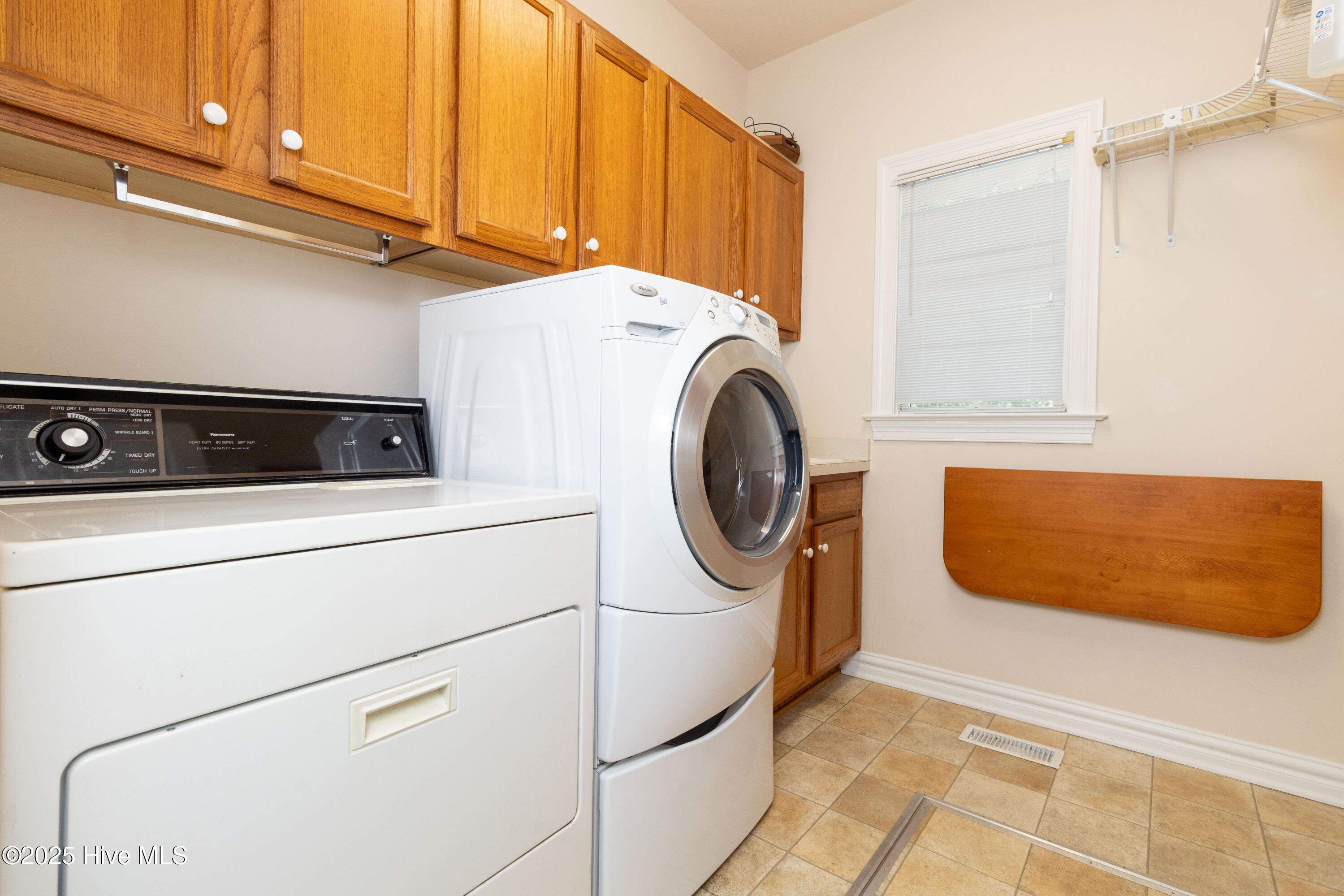 Laundry room with sink and trap door to crawl space