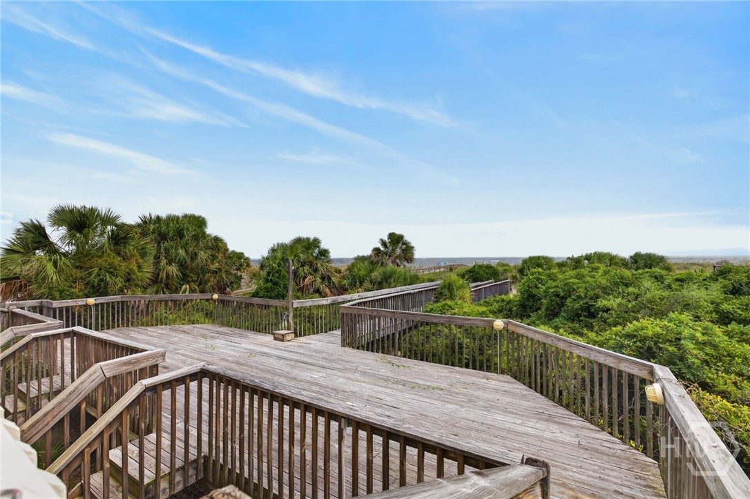 Deck on beachside of building with outdoor shower.