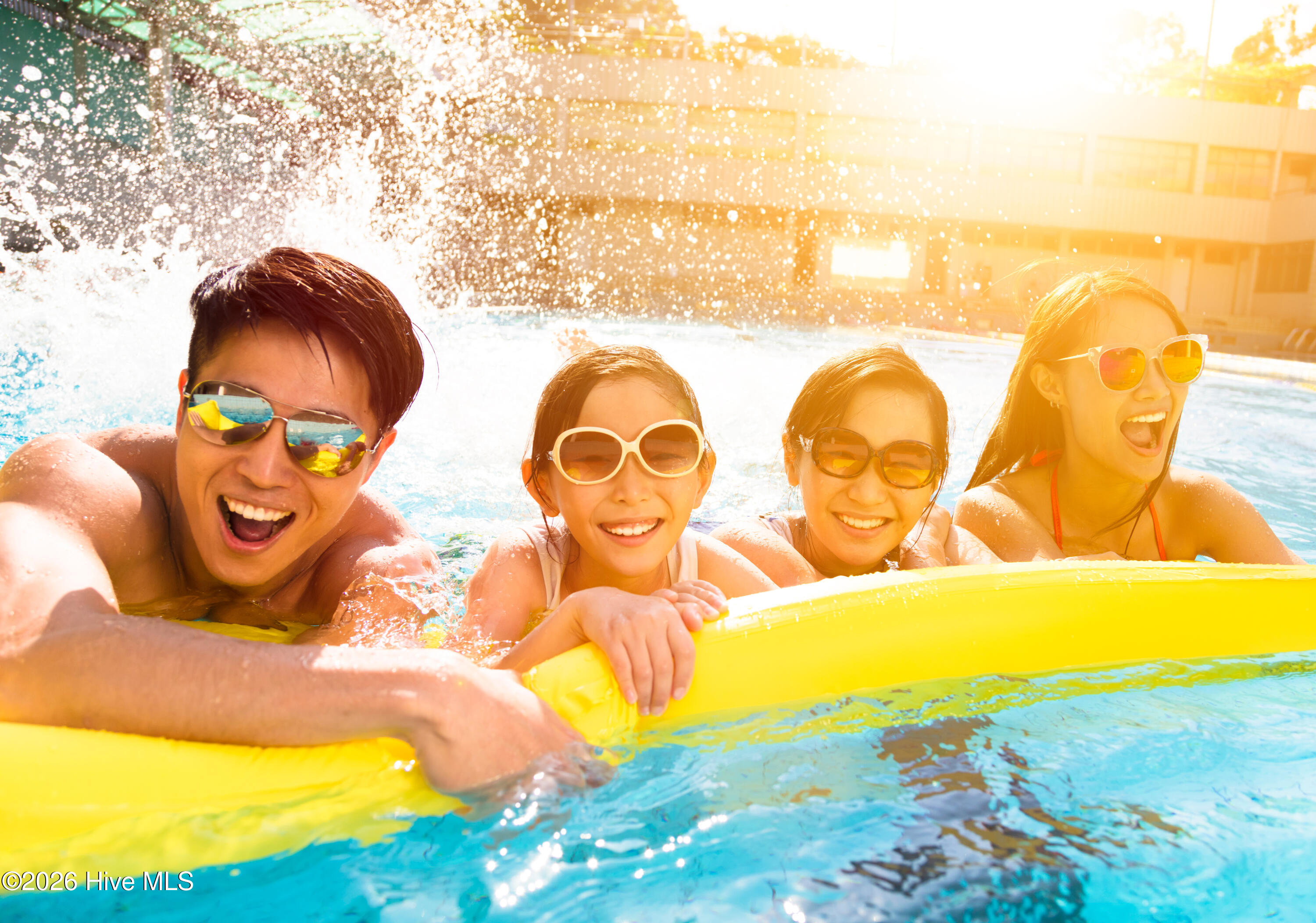 Asian Family with Pool Noodle in Pool