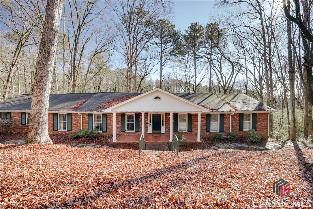 Rare opportunity in the highly desirable Bedgood-Glenwood neighborhood! 360 Glenwood is a spacious 5-bedroom, 4-bath home with incredible potential, offering a fantastic chance to create your dream home. Situated on a sprawling 1.6-acre private wooded lot, this well-maintained brick split-level ranch is a testament to true quality construction.Step inside to a welcoming foyer that opens into an oversized living room and a spacious dining area—perfect for entertaining. A stunning fireplace and custom-crafted built-in cabinetry add charm and character. The expansive kitchen includes a breakfast room, while the adjacent den boasts floor-to-ceiling windows that bring in beautiful natural light, complemented by an inviting fireplace.An additional sunroom, complete with a hot tub, leads to an elevated backyard deck overlooking fenced-in landscaping and serene nature views. The main-level primary suite features an ensuite bath with a jacuzzi tub, separate shower, and two spacious walk-in closets. Two additional bedrooms on the main floor each have their own ensuite bathrooms, offering convenience and privacy.Downstairs, a separate apartment provides a flexible space—ideal for a rental opportunity, guest suite, or bonus area. It features a den with a fireplace, a bedroom with an ensuite bathroom, and an additional room with a closet that could easily transform into a bedroom.  With over 4200 square feet of living space, this home is a true gem with unlimited possibilities to customize and modernize to your taste.Located just blocks from the heart of Five Points, you’re minutes from Athens’ award-winning restaurants, boutique shopping, and vibrant nightlife—including Five & Ten, Marker 7, ZZ & Simone’s, The Expat, and more. The property is also conveniently close to the University of Georgia campus, Intramural Fields, Ramsey Center, and Sanford Stadium. Zoned for the distinguished David C. Barrow Elementary, this home is a rare find for those looking to invest in a prime location.Don’t miss out on this incredible opportunity—whether you're looking for a full-time family home or an investment property, this home has endless potential!