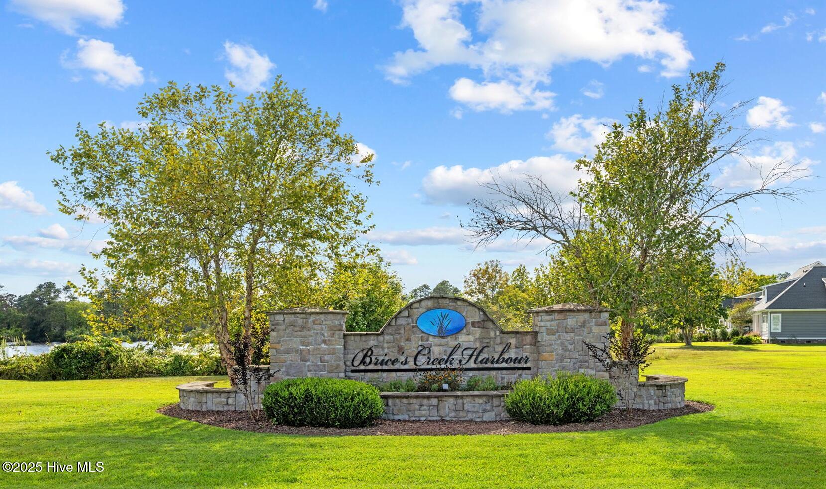 Beautiful welcome sign as you enter with a peek-a-boo water view.