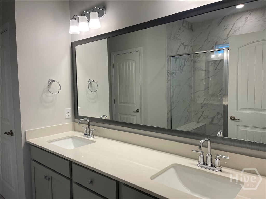 Double Vanity with Quartz Countertops in Primary