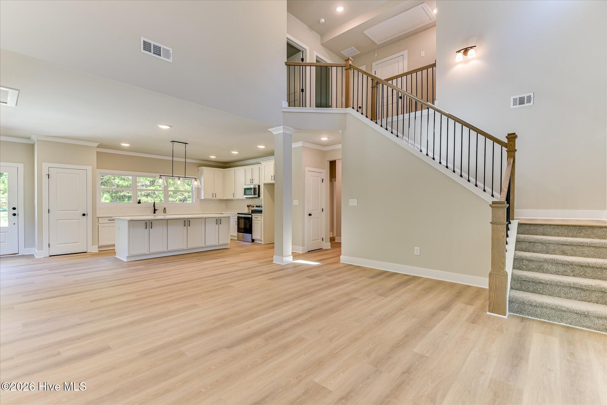 Three bedrooms and two full bathrooms are downstairs; two bedrooms, a full bathroom, and a utility room are upstairs.