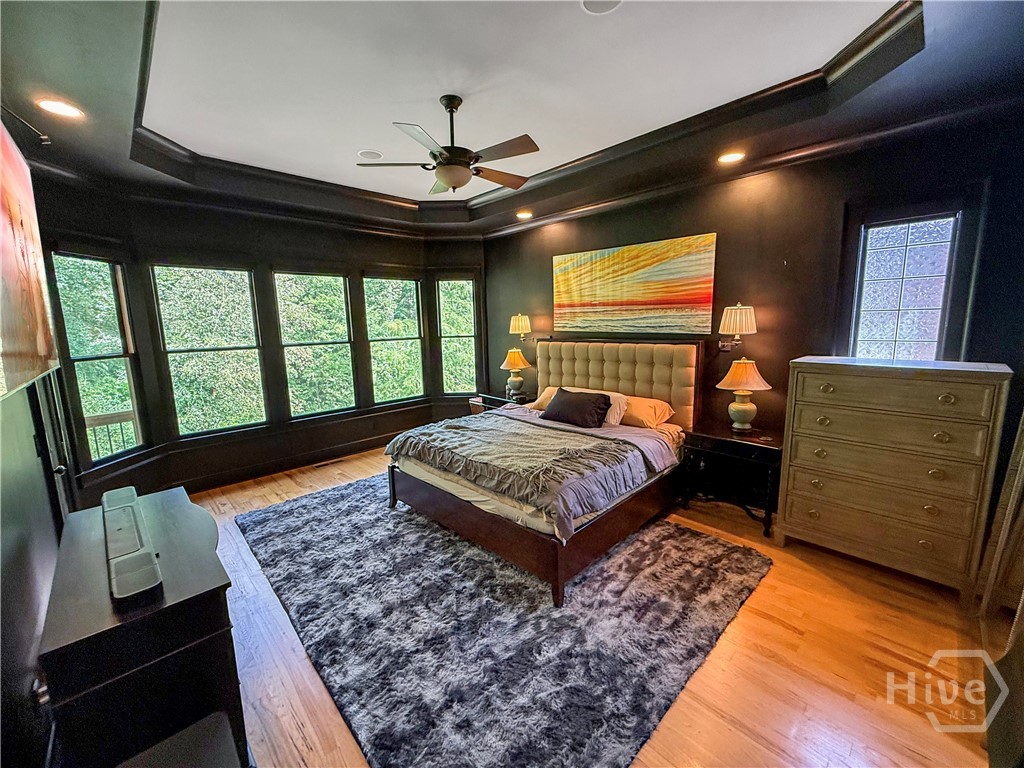 Master Suite w/tray ceiling and windows with views of  nature, pond and water fountain.  Blinds are automated to close for privacy.