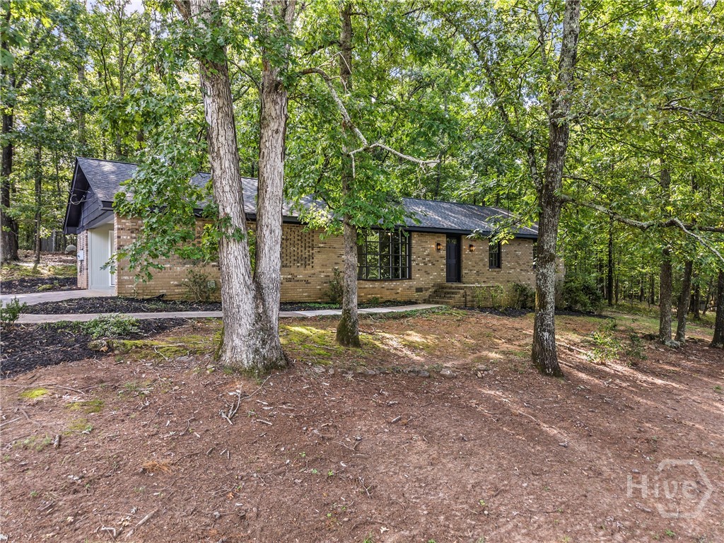 Location is everything, and this all-brick charmer delivers! Welcome home to this beautifully renovated, all-brick 3 bedroom, 2 bath ranch in one of Athens’ most desirable locations—Kingswood Subdivision, directly across from Timothy Road Elementary! It sits on almost an acre. This home blends modern updates with classic charm, featuring a cozy fireplace, spacious living areas, and a 2-car carport for everyday convenience. The private, wooded lot offers room to relax, along with a large fenced dog kennel that’s perfect for pet lovers. Whether you’re sipping coffee on the back patio or entertaining friends, you’ll appreciate the peaceful setting while still being just minutes from shopping, dining, UGA, Downtown Athens, Hwy 316 and Hwy 78.  Move-in ready and in a highly desirable area, this home checks all the boxes!