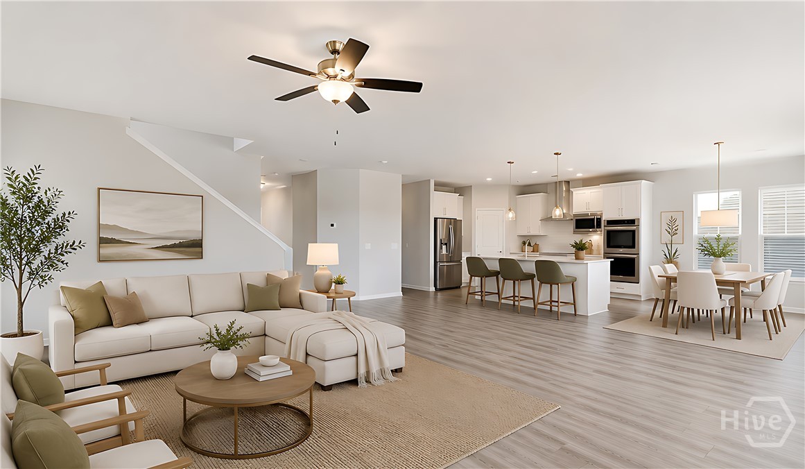 Galley kitchen flowing into a staged living area