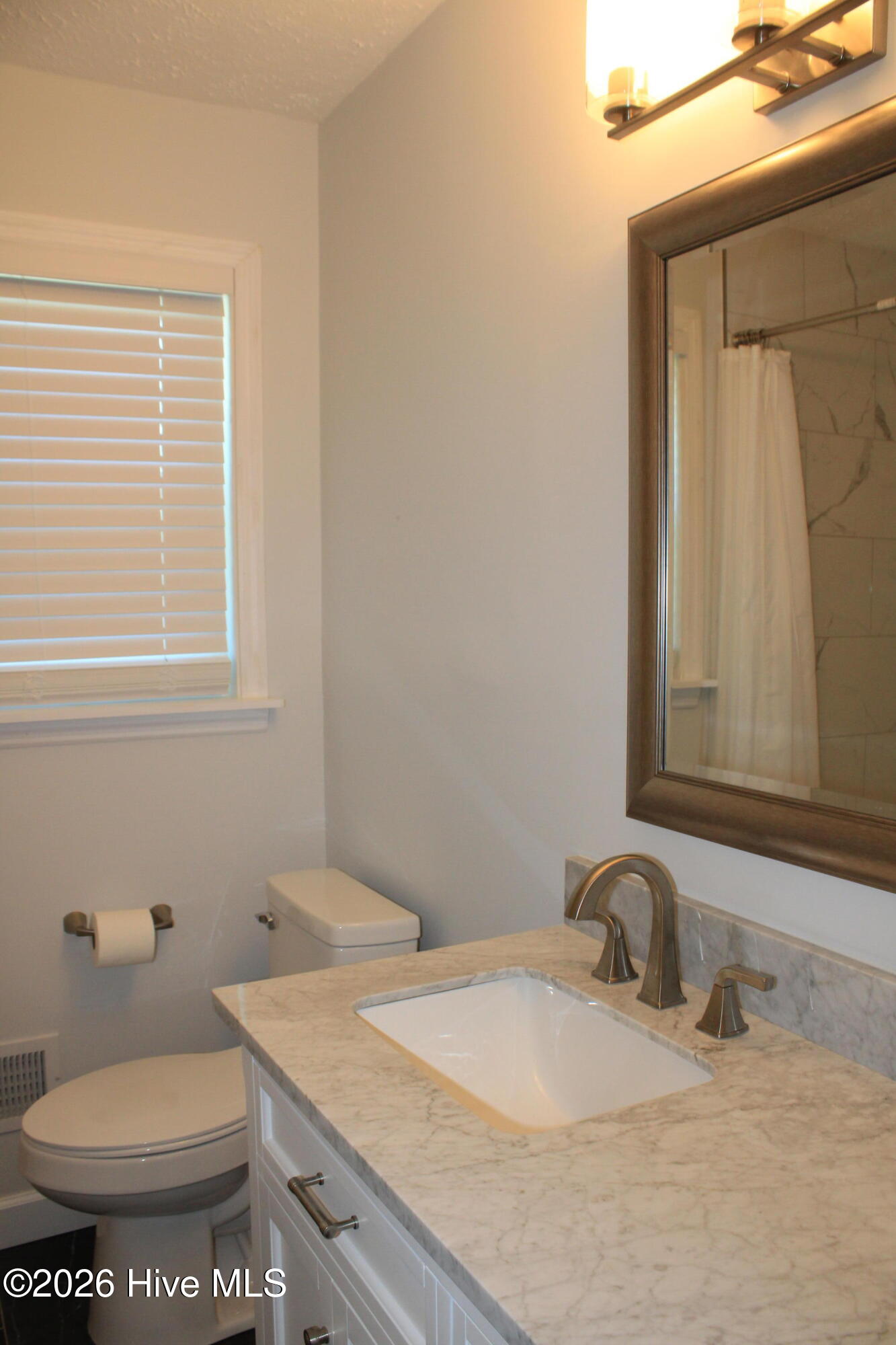 Single vanity, granite countertops w/ framed mirror