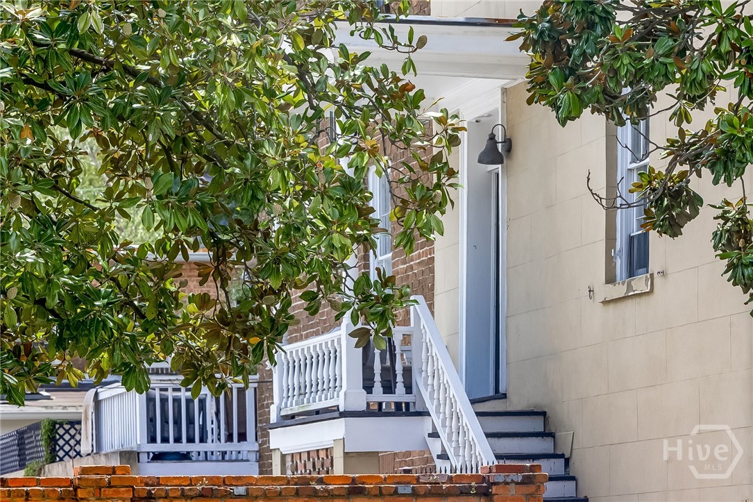 Sidewalk view of entrance to the upper apartment.