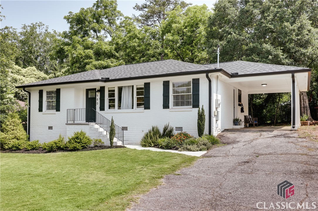 Practically Normaltown without the Normaltown price! Welcome to 980 Oglethorpe Avenue, the most charming brick cottage for only $350k! With 3 bedrooms, 2 baths, fully renovated and a private backyard, this home checks all the boxes and is just around the corner from all Normaltown has to offer.1960s brick ranches are always a solid bet, but this one ups the ante: The white painted exterior with dark trim and tasteful landscaping are eye-catching, and the attached carport provides covered parking. Inside, gorgeous hardwood floors run throughout the home and natural light flows in from the huge windows. The renovated kitchen features quartz countertops, subway tile, brass hardware and a gas range. The dining and living rooms are open to the kitchen and make entertaining a breeze. A convenient laundry closet is tucked next to the kitchen as well. Three bedrooms and two full baths are located down the hall, including a primary suite. Both baths feature tile floors and shower surrounds with modern cottage styling. Outside, the backyard is private and ready for morning coffee or evenings with friends and family. The backyard is almost fully fenced and can easily accommodate any furry friends. Plus, the renovations on this home go beyond just aesthetics: the architectural shingle roof is 3 years old, the HVAC is 4 years old, there is newer plumbing and electric throughout and there is an active termite bond.Did we mention location?! Sidewalk access brings you to Bishop Park for the Athens Farmers Market, YMCA, summer nights at Automatic Pizza + Normal Bar, and popups at the Old Pal. Piedmont Hospital is just a few blocks further, and Downtown Athens and the University of Georgia are only a couple miles away. Don’t wait to see this awesome value for in-town living in Athens!