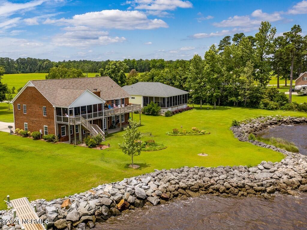 804 Murphy Farm Road Merritt, North Carolina Situated on nearly an acre of beautiful waterfront on the Bay River, this gorgeous 3-bedroom 3.5 bath home offers sweeping water views from most every room. Exceptional features include an open living area with a dramatic cathedral ceiling and fireplace, updated kitchen, island eat-in area, pantry, master bedroom with ensuite bath and ample walk-in closet, separate laundry room. A climate controlled 2000 sq. feet plus walk-out basement with hobby rooms and workshop area also provides two car parking and plenty of room for water toys. Chairlift for maneuvering stairway from the basement/garage area of the home. For outdoor pleasure, there's a large waterside deck and spacious screened in porch.