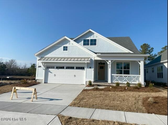 Discover the Cypress model by builder Legacy Homes by Bill Clark, this spectacular home sits on a picturesque lot with unbelievable pond views from nearly every room—the kitchen, main living areas, screened porch, upstairs bedrooms, rec room, and second-floor covered porch. Experience the best of nature-view living in this stunning 3,038 square foot, 5-bedroom, 4.5-bathroom home. The heart of the home features a great room with exposed beams and built-ins flanking the fireplace, flowing into a prestige kitchen with gas cooktop, built-in wall oven and microwave, and walk-in pantry. Center-meet sliders open to a large screened porch and grilling patio with charming brick border, perfect for entertaining while overlooking the tranquil water views. The oversized primary suite offers a peaceful retreat with mature tree views, featuring a spacious bathroom with freestanding tub, walk-in shower, and an oversized closet with custom white wood shelving that connects directly to the laundry room. The first floor also includes a convenient powder bath and secondary bedroom with private en-suite. Upstairs, discover endless possibilities with three additional bedrooms, two bathrooms, and an oversized rec room with stunning vaulted ceiling. Step out onto the second-story covered porch to capture scenic pond and tree views—perfect for morning coffee or peaceful evening retreats. Conveniently located on the second floor are two large walk-in storage areas—semi-conditioned with Legacy's included spray foam insulation—providing practical space for all your storage needs. Nestled in the intimate 30-homesite Collingwood Cottages neighborhood within Brunswick Forest's vibrant community, you'll enjoy low-maintenance living with HOA-included lawn care while having access to all the lifestyle amenities.