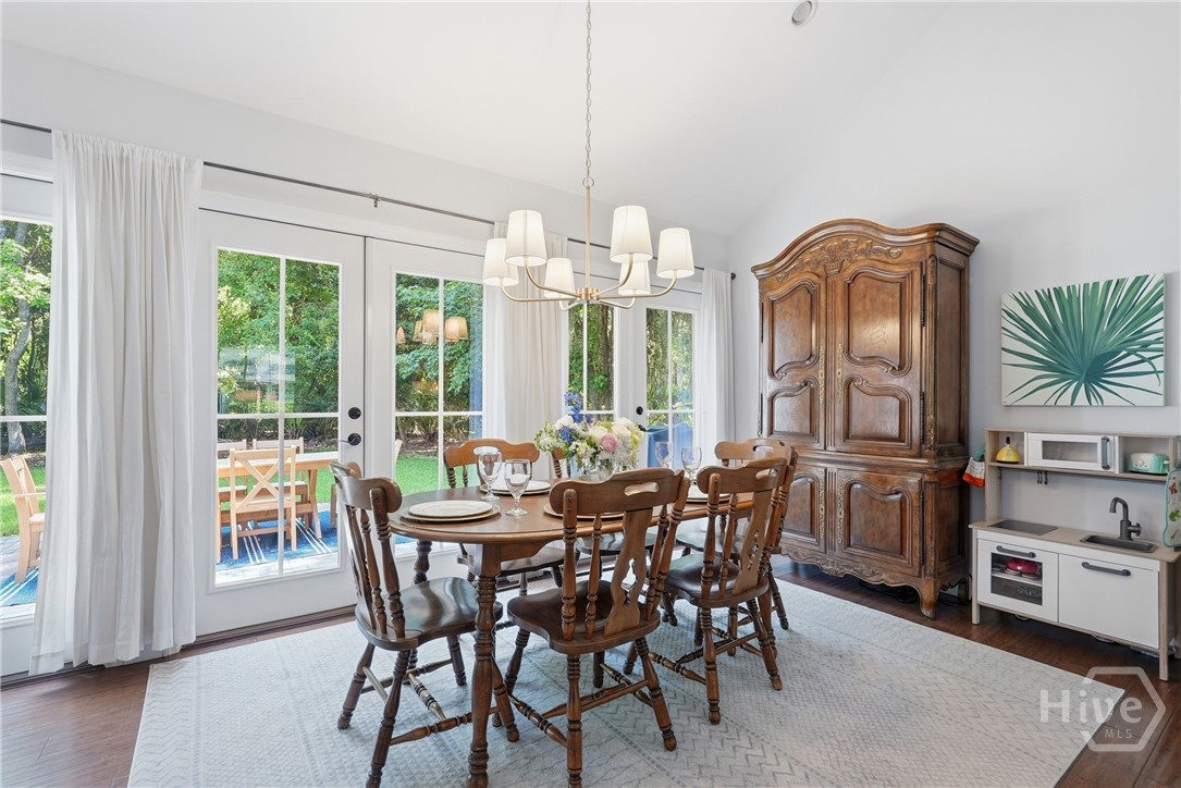 Dining room in family room with tons of natural light, vaulted ceilings