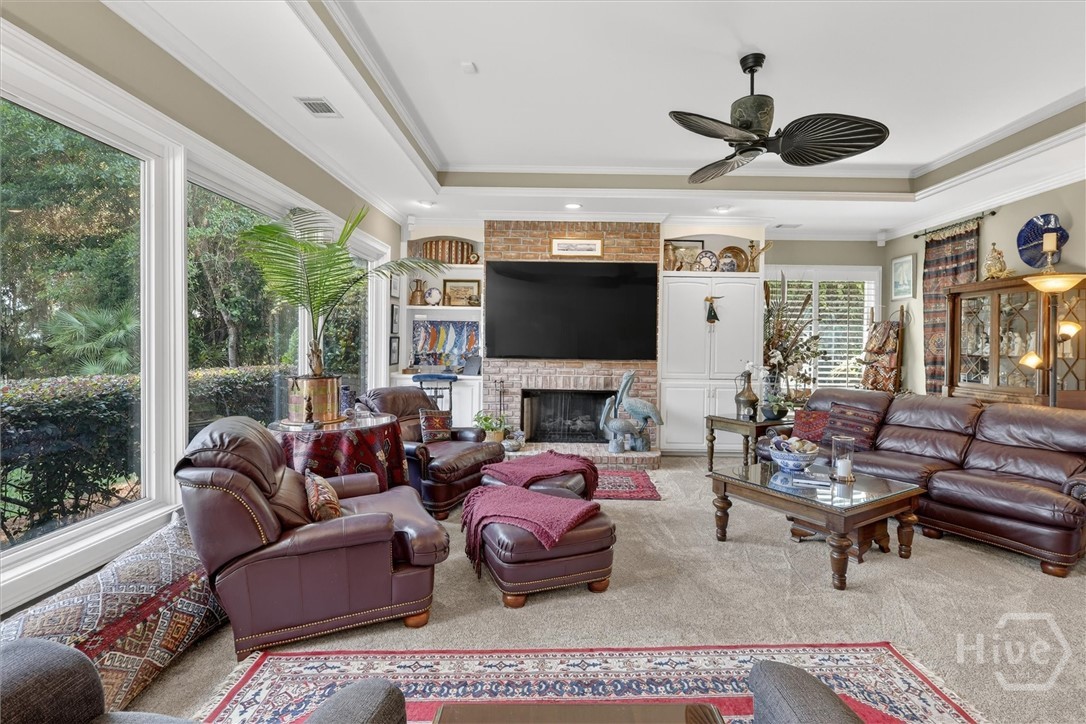 Great room with brick fireplace, built-ins, and fl