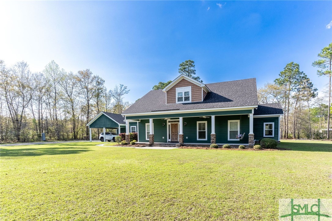 Nestled on 5 acres, this 4 bedroom Lowcountry gem blends rustic charm with modern comforts. Featuring an inviting living area with soaring ceilings, a cozy fireplace flanked by bookshelves, and a seamless flow into the gourmet kitchen. The main-level master suite offers a pass-through from the closet to the laundry room. A second downstairs suite is perfect for guests. Enjoy the outdoors on the covered porch with a gas fireplace. Upstairs hosts a versatile loft, two spacious bedrooms, and walk-in attics with spray foam insulation. Complete with a charming pet wash station, this home is a peaceful sanctuary.