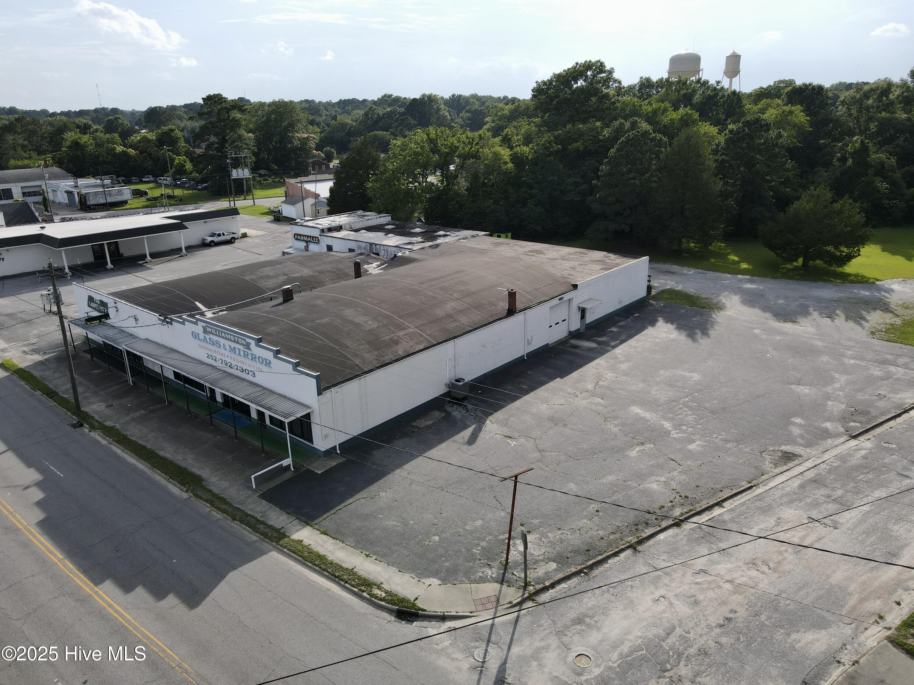 Searching for the ideal storefront property to take your business to the next level? This is your chance to own an impressive 8,700 sq. ft. building in a prime, high-traffic location in Williamston, NC. Positioned along one of the town's busiest thoroughfares, this property offers unmatched visibility and a location that's hard to beat.
The versatile layout is designed to meet a variety of business needs. The front features space for an office and an attractive windowed storefront, while the middle section provides ample working areas. At the rear, you'll find a spacious warehouse and garage space, perfect for storage or operational use. Previously home to several successful businesses, this property is ready to become the foundation of your next venture in Williamston, NC!