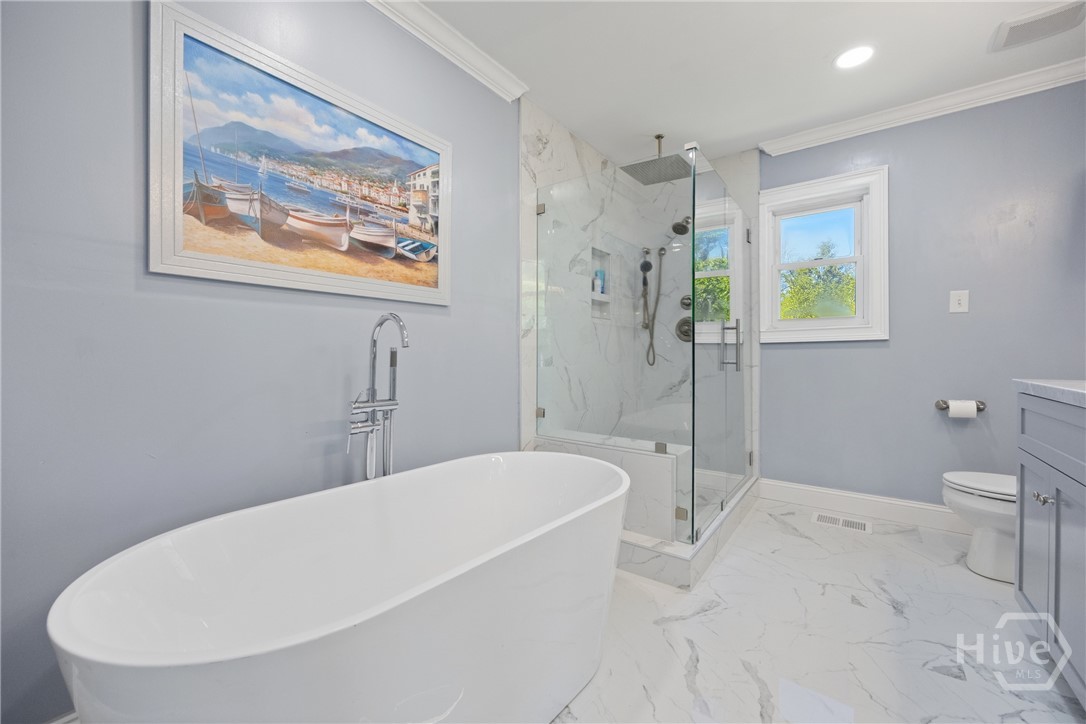 Beautifully renovated bathroom featuring a soaking