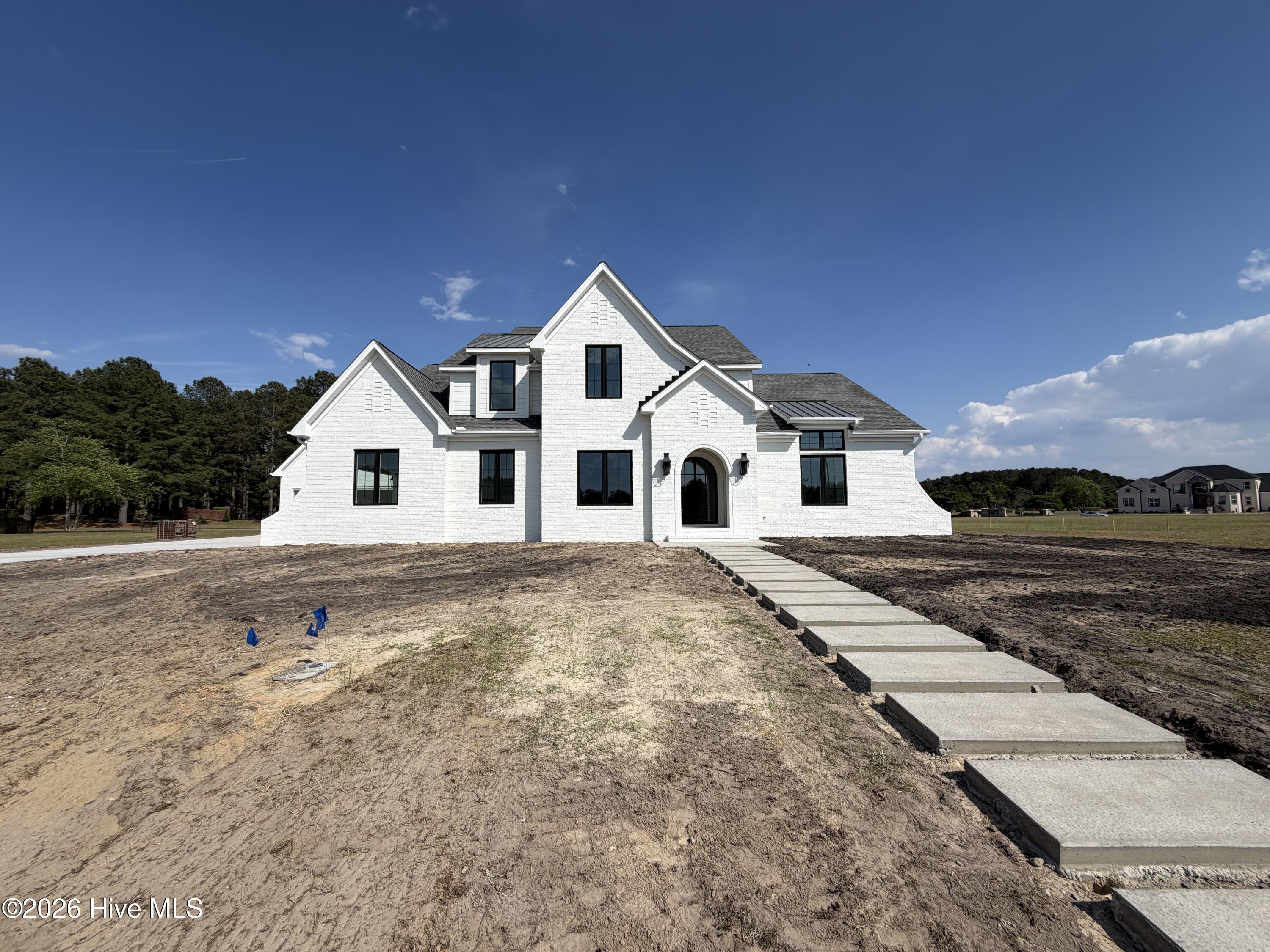This signture sidewalk will bring your guest to the coved front porch with arched glass doors !