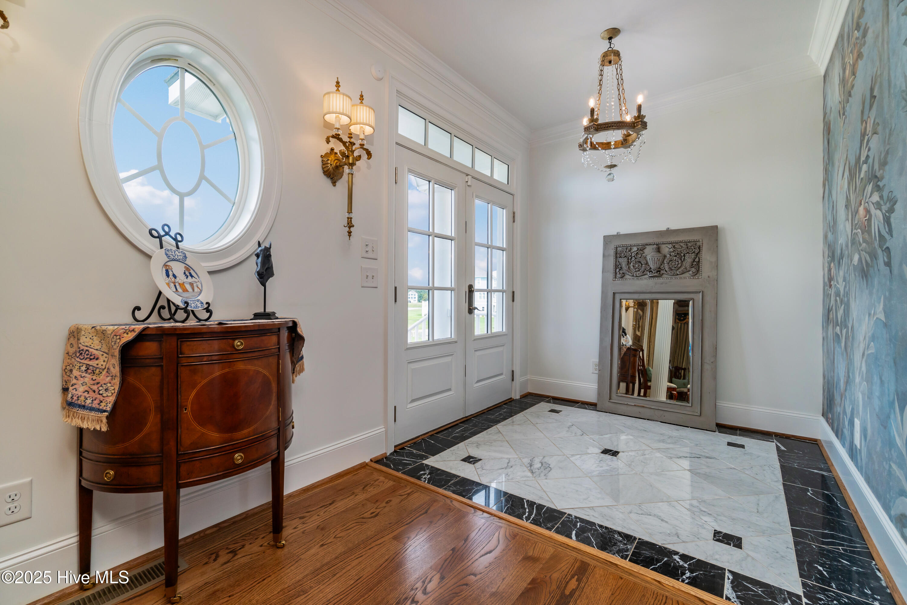 designer wallpaper and marble floors greet guests in the foyer