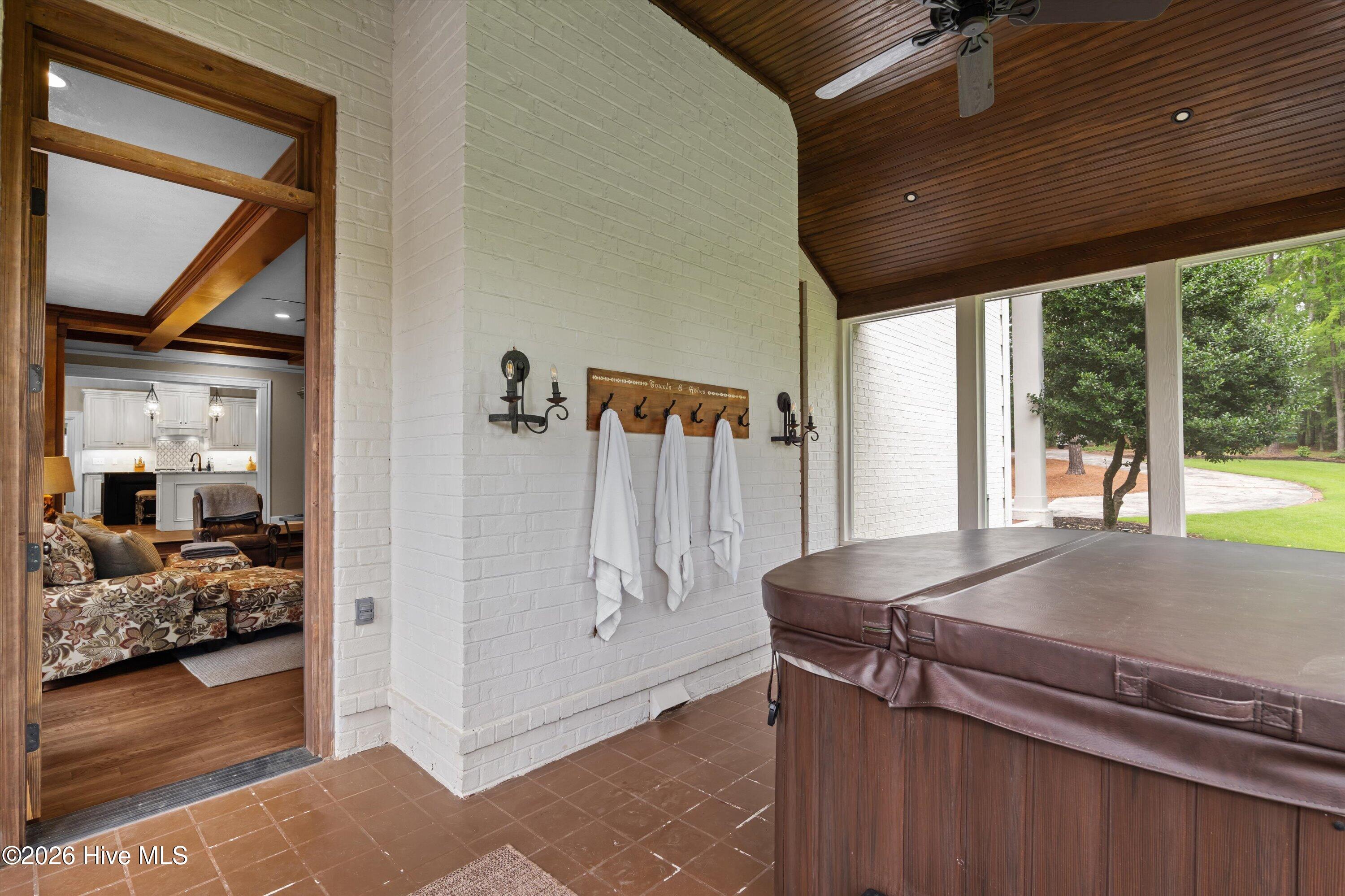 Enclosed side porch off of living room with hot tub
