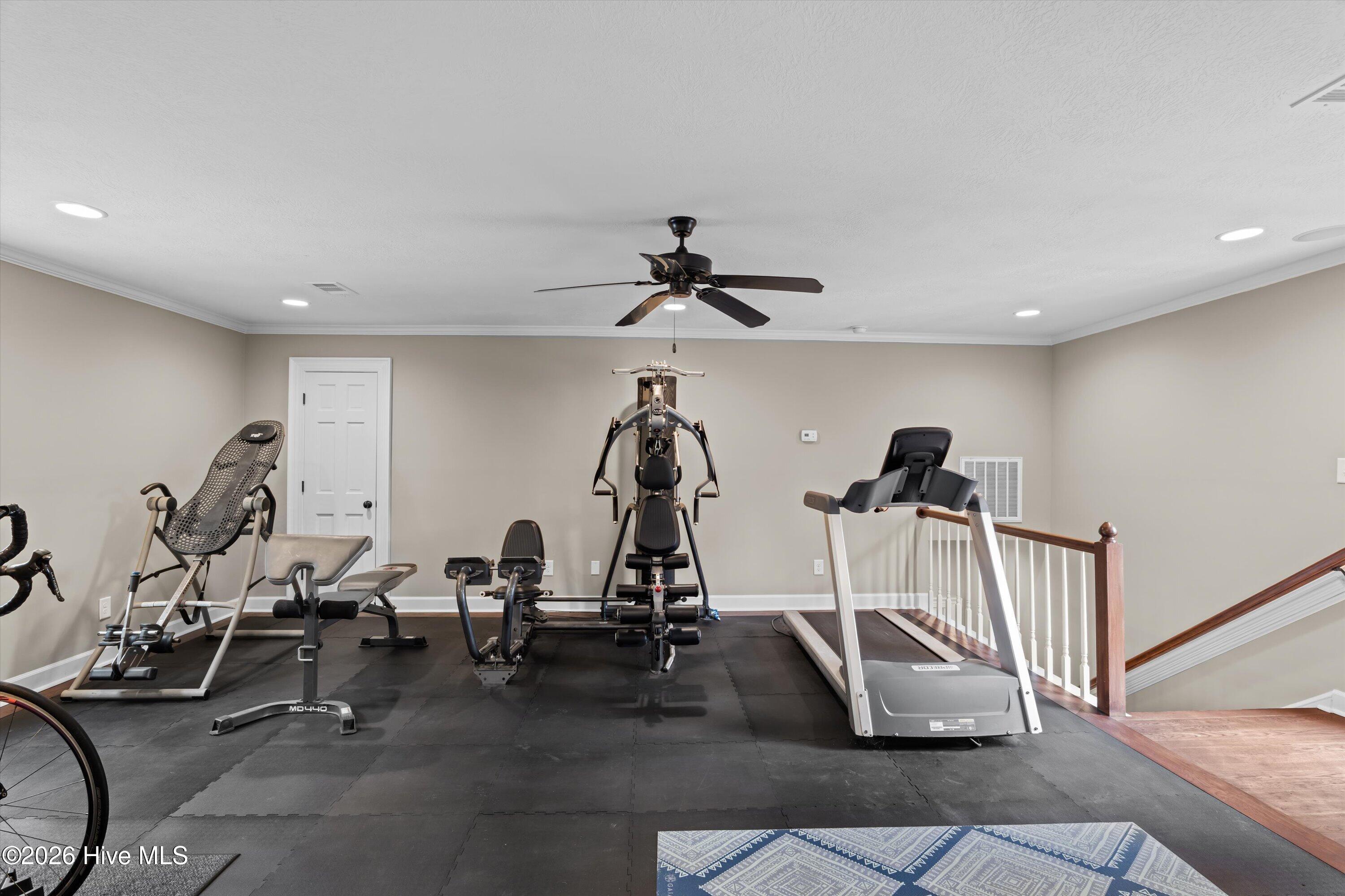 Bedroom #4 currently used as a home gym includes 2 walk in closets, office area and a full bath