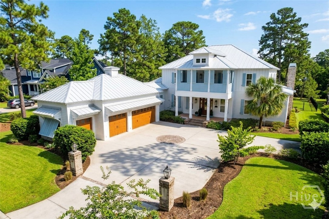 WATERFRONT LUXURY ON THE GRAND LAGOON! Inspired by the renowned Amelia Island Idea House, this extraordinary custom home delivers timeless Lowcountry style, exceptional craftsmanship, and resort-style living on a private 0.73-acre lot in Waterways. From the crape myrtle-lined drive and gas lanterns to the double front balconies and protected wooded views, every detail makes a lasting impression.Inside, French white oak floors, exposed beams, shiplap, rich millwork, and designer lighting create an elevated yet welcoming atmosphere. The showstopping chef’s kitchen features ceiling-height antique white cabinetry, a 48-inch KitchenAid range with pot filler, custom hood and backsplash, Thermador built-in refrigerator/freezer, wine cooler, walk-in pantry, and drop zone.The main-level owner’s suite offers a gas fireplace, French doors to the porch, and a spa-inspired bath with custom James Martin vanities. A private study, lagoon-view breakfast room, and expansive screened porch with wood-burning fireplace and outdoor kitchen make entertaining effortless.Upstairs are three additional bedrooms, including two guest suites, plus a spectacular media room with built-ins, gas fireplace, wine cooler, and access to a screened balcony with swinging beds and serene lagoon views. Maintenance-free Zuri decking spans every porch and balcony.The fenced backyard features a paver fire-pit patio with room for a future pool and leads to a private dock with water and electricity—perfect for kayaking, paddleboarding, fishing, or relaxing by the water. Additional highlights include 3.5-car garages, spray foam insulation, and Emtek hardware.Enjoy Waterways amenities including a marina, championship bass fishing, pools, fitness center, trails, dining, shopping, clubs, and year-round events. Now offered at an exceptional new price—this is Lowcountry waterfront living at its finest! (photos were enhanced)