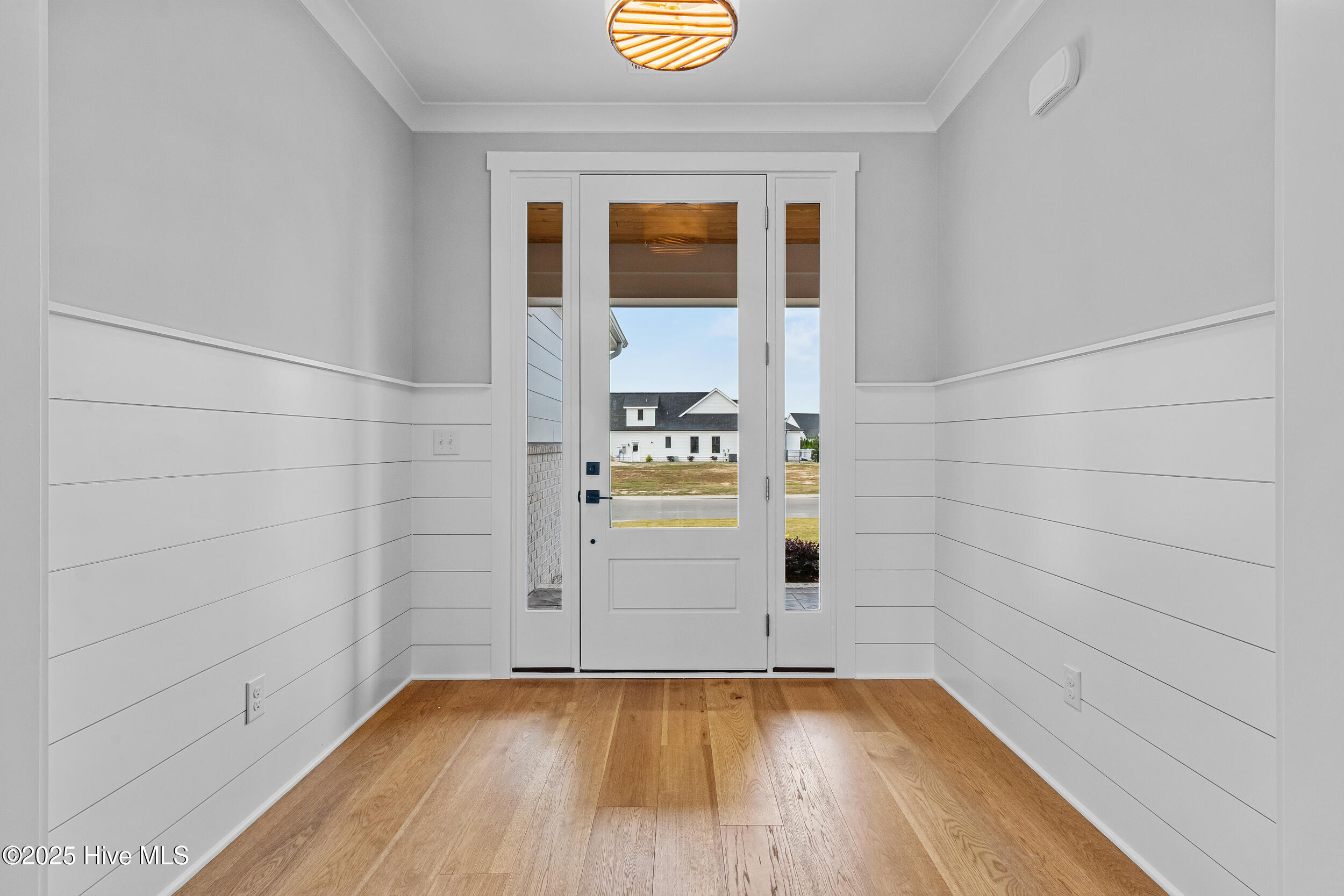 Foyer with engineered hardwood flooring throughout home