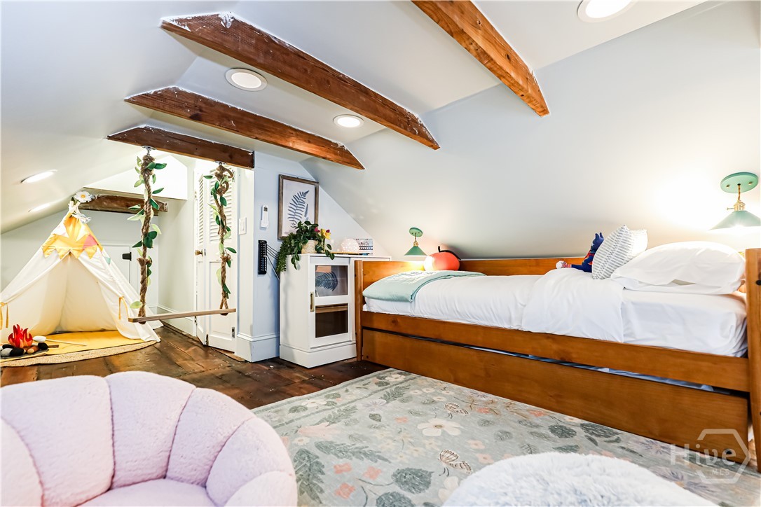 Bunkroom and play area with separate attic storage room