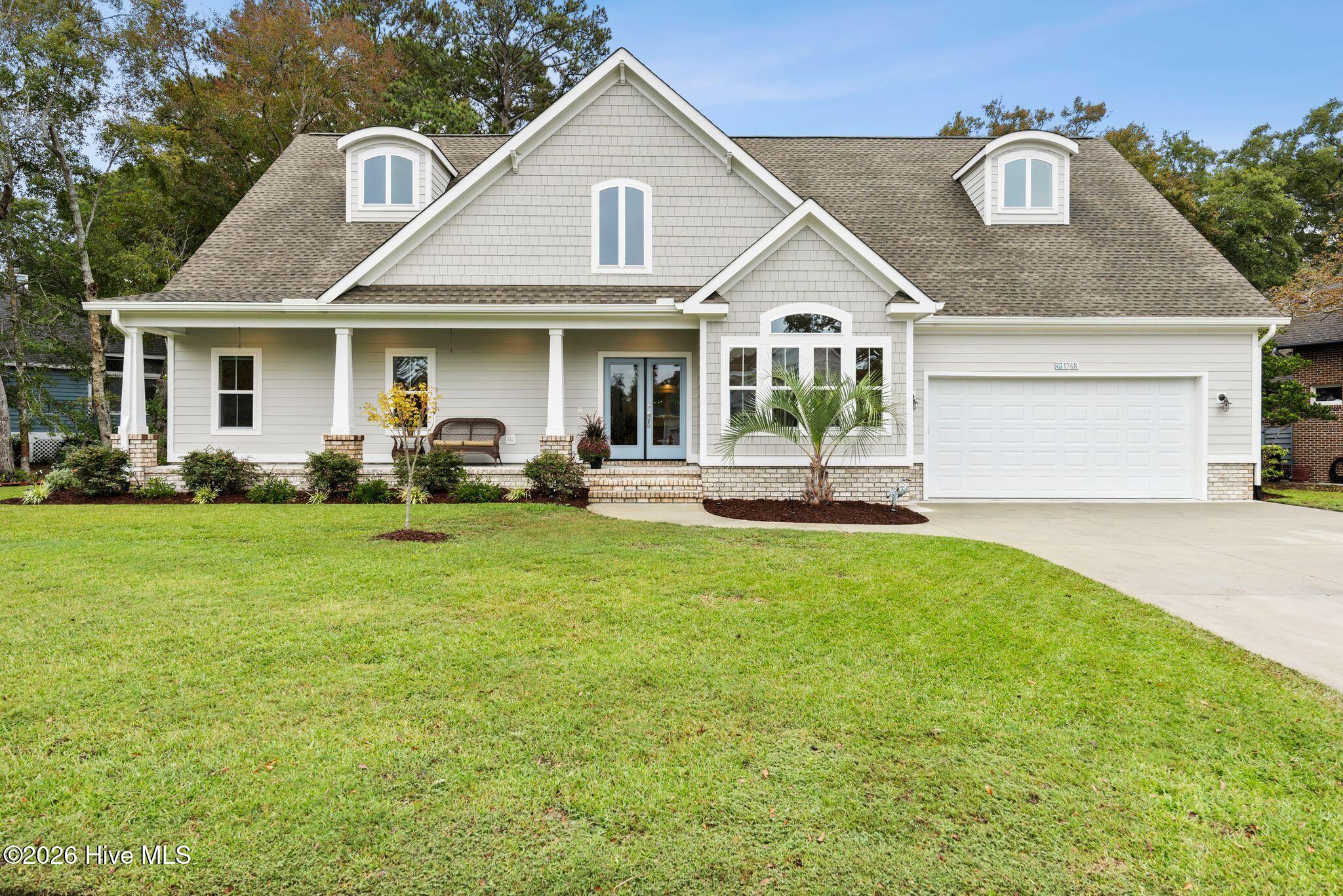 Nearly new golf-course living in gated Brick Landing--where thoughtful design, exceptional storage, and inviting indoor-outdoor spaces come together beautifully. Built in 2024, this impressive 4-bedroom, 3.5-bath home offers a desirable first-floor primary suite, spacious 3-car garage, and a floor plan designed for comfortable everyday living and effortless entertaining.Step inside to bright, welcoming living spaces that flow naturally through the heart of the home. The kitchen is complemented by a sumptuous oversized pantry with dedicated office space, creating the perfect place for meal prep, additional storage, a coffee station, or working from home while keeping everything conveniently tucked away. The first-floor primary suite provides a private retreat, while three additional bedrooms offer plenty of room for family, guests, hobbies, or additional workspace.Outdoor living is just as impressive. Start your morning on the large, inviting front porch, then relax or entertain on the expansive screened back porch and fenced-in backyard overlooking the golf course. From quiet mornings with coffee to evenings with friends, these generous outdoor spaces invite you to slow down and enjoy the beautiful coastal Carolina setting.The 3-car garage is a standout feature of its own. Equipped with a mini-split heating and air-conditioning system and extensive oversized built-ins, it provides exceptional climate-controlled space for vehicles, storage, hobbies, a workshop, golf equipment, and all your beach gear.Located in Brick Landing, a gated and well-established Ocean Isle Beach community known for its mature landscaping, beautiful tree-lined surroundings, and distinctive homes, this property offers the rare opportunity to enjoy the advantages of 2024 construction within a neighborhood that already feels established and welcoming. Peaceful golf-course surroundings complete the setting, while Ocean Isle Beach, shopping, dining, medical services, golf, and area attractions are all just minutes away.