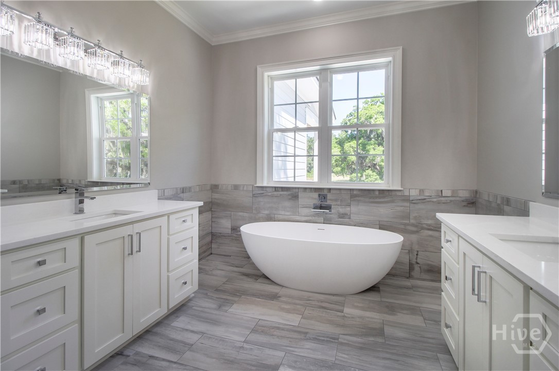 Pretty master bath with slipper tub and his/her vanities