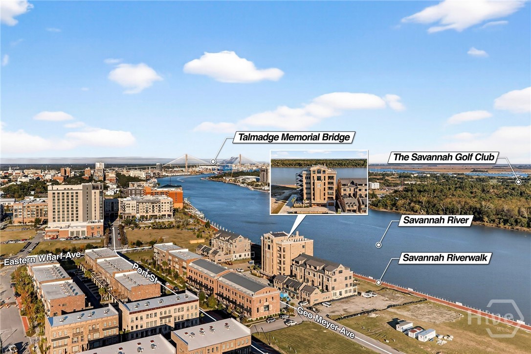 Aerial View of Prime Riverfront Property - A sweeping aerial perspective reveals the property's enviable location near iconic landmarks, lush greenways, and the Talmadge Bridge-anchoring it within Savannah's most coveted riverfront corridor.