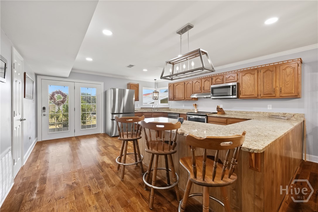 Bright kitchen with ample cabinetry, granite count