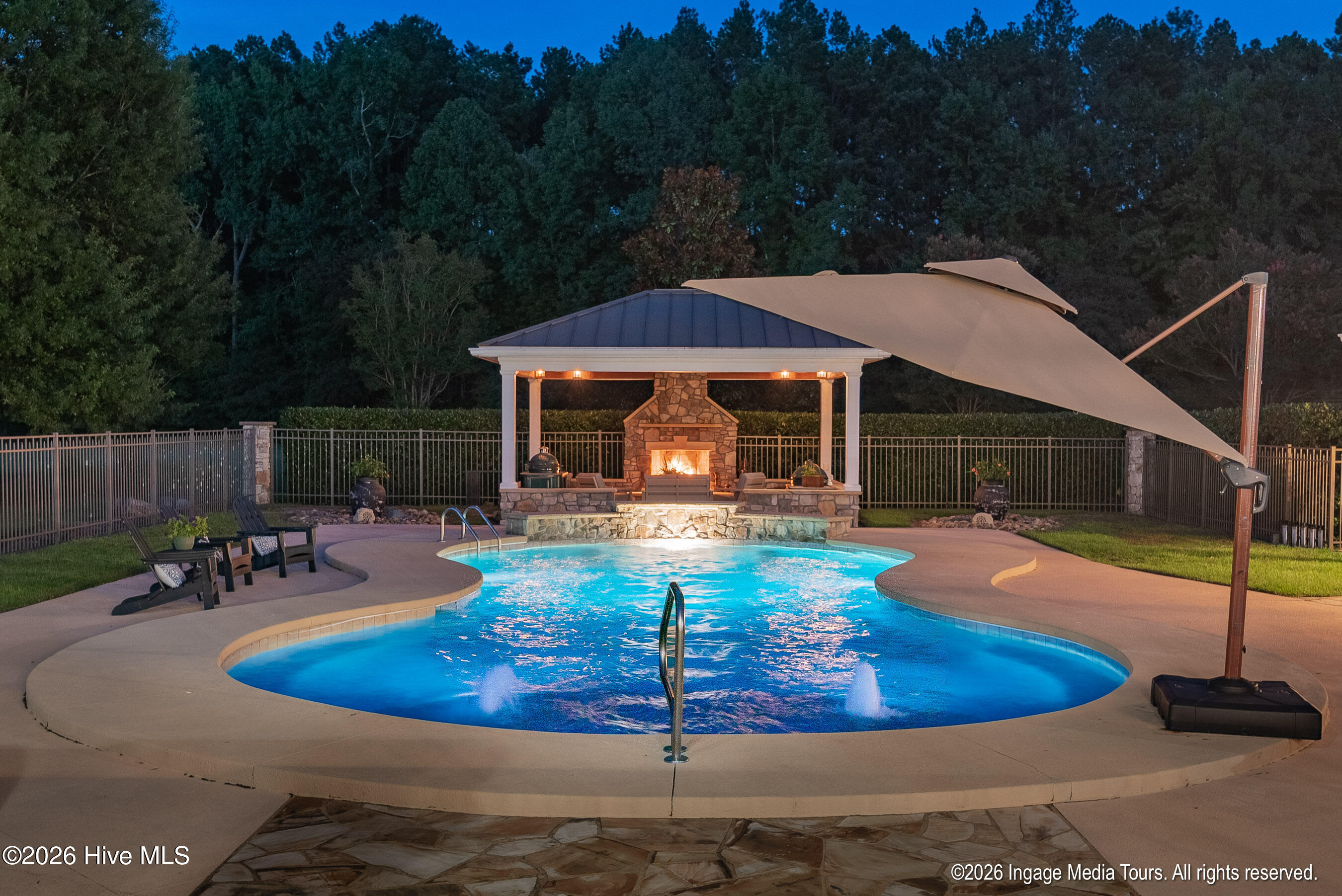 View of Pool and pavilion at night.