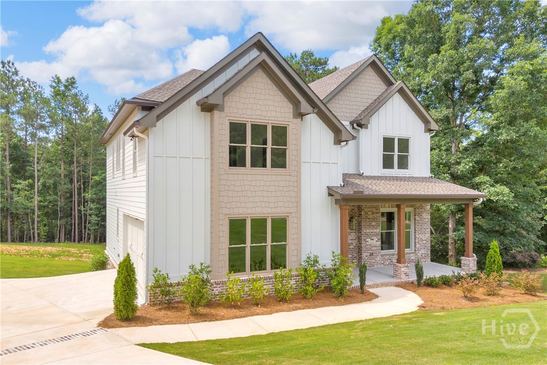 Craftsman New Construction - two-story residence featuring a covered front porch with stone pillars