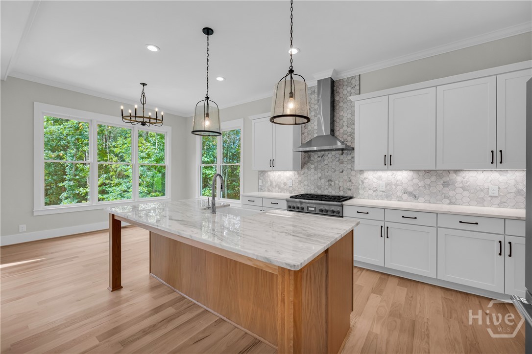 Stunning chef’s kitchen featuring marble and quartz countertops, a complete Thermador stainless steel appliance package, 5-burner natural gas cooktop, dedicated coffee station, and an impressive butler’s pantry for added storage and entertaining convenience